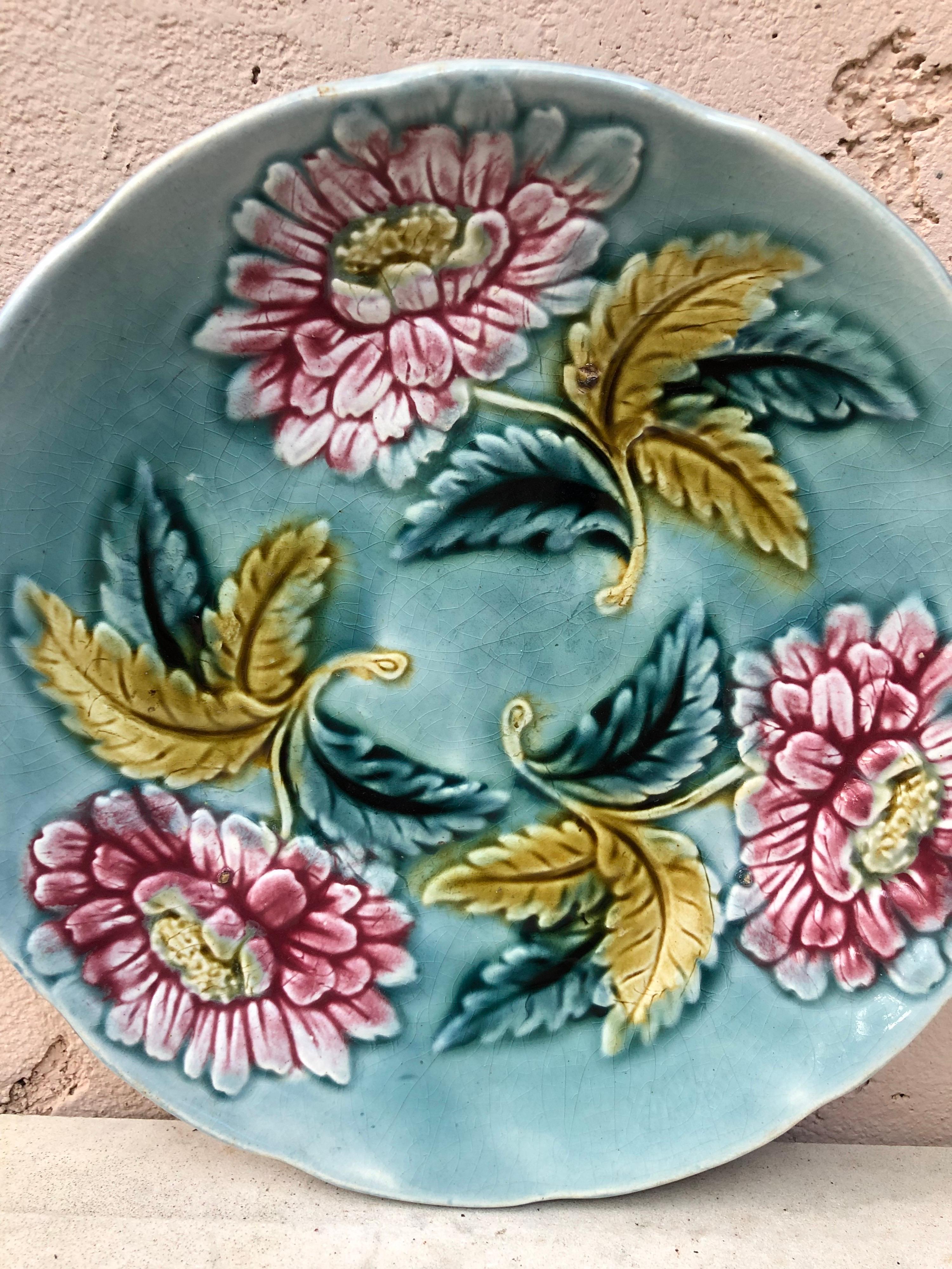 19th-century blue Majolica plate with red flowers.