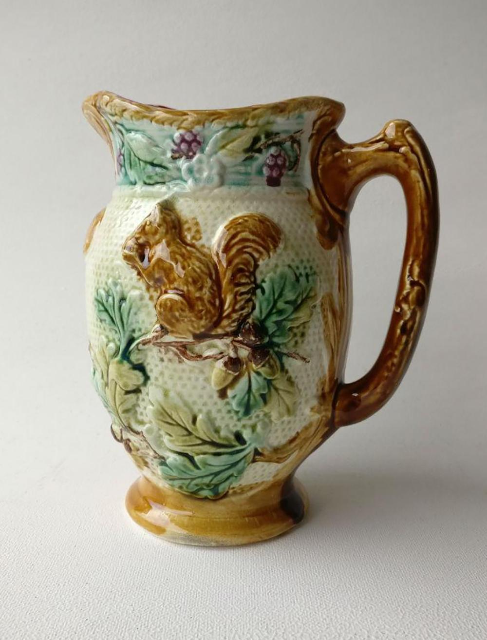 French Majolica pitcher with a squirrel on a oak branches eating a nut signed Onnaing number 372, circa 1880.
     