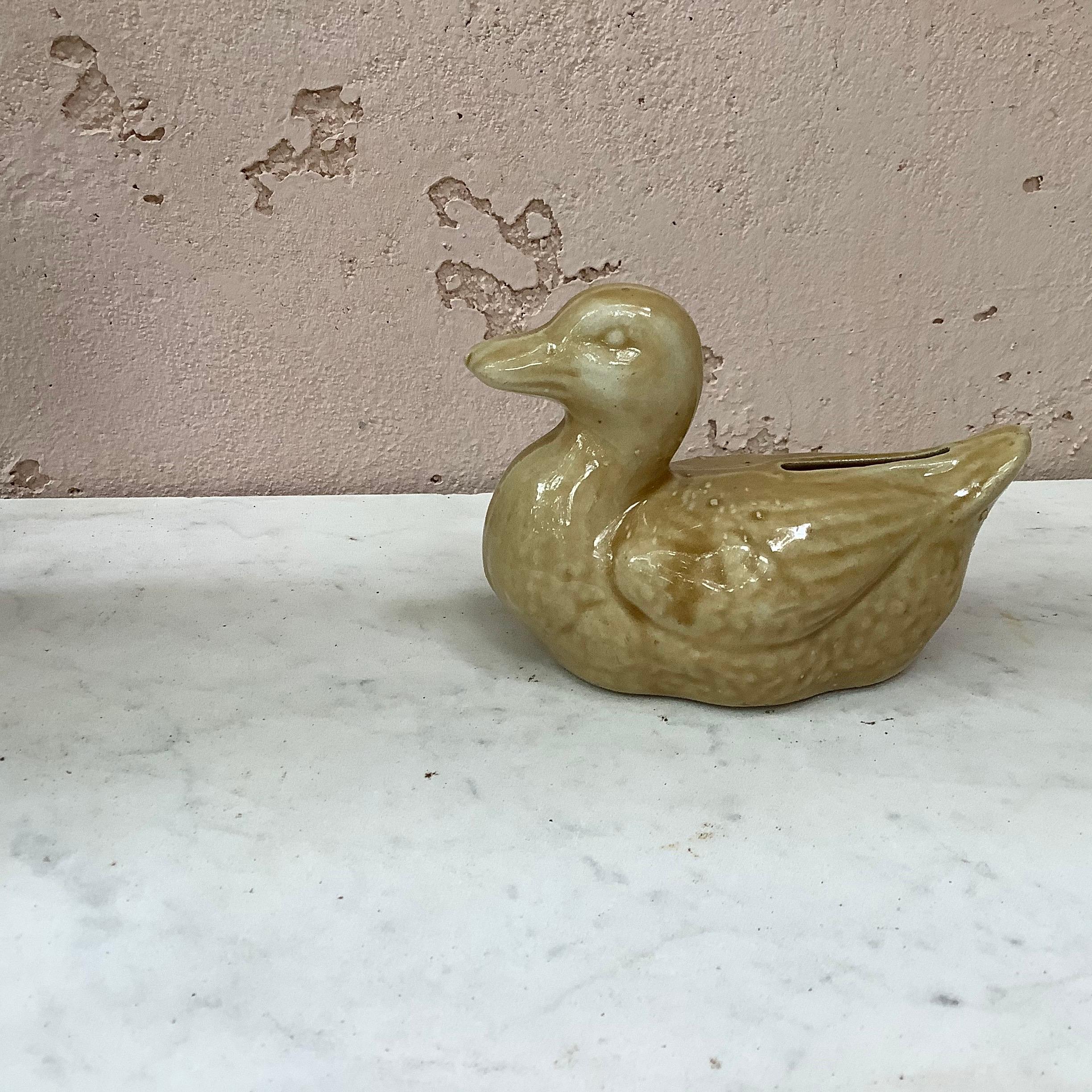 Antique French Majolica yellow duck money bank, circa 1900.