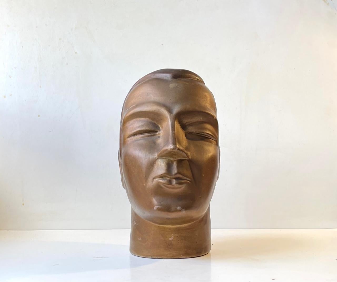 A natural or slightly oversized male mannequin head in painted pottery/plaster. Distinct Art Deco styling with exaggerated features. Made in France circa 1930. Perfect for displaying sunglasses, hats etc. Measurements: H: 30 cm, W: 15 cm, Dept: 20