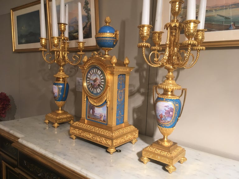 Ormolu French Mantel Clock and Candelabra of Gilt Bronze and Blue ‘Sèvres’ Porcelain For Sale