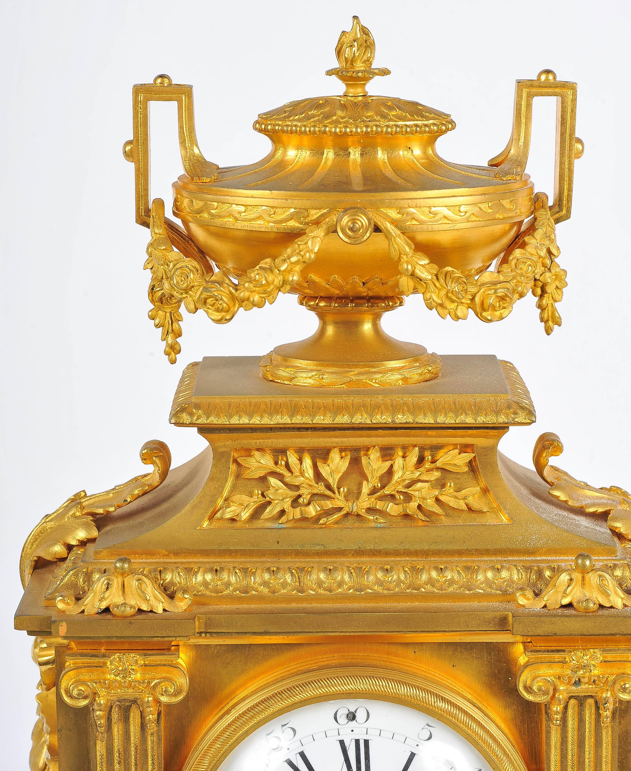 A good quality French Louis XVI style, gilded ormolu mantel clock, having an urn to the top with swags, pierced ormolu panels, Cornucopia and columns on either side of the clock face. The white enamel dial with an eight day striking movement.
    