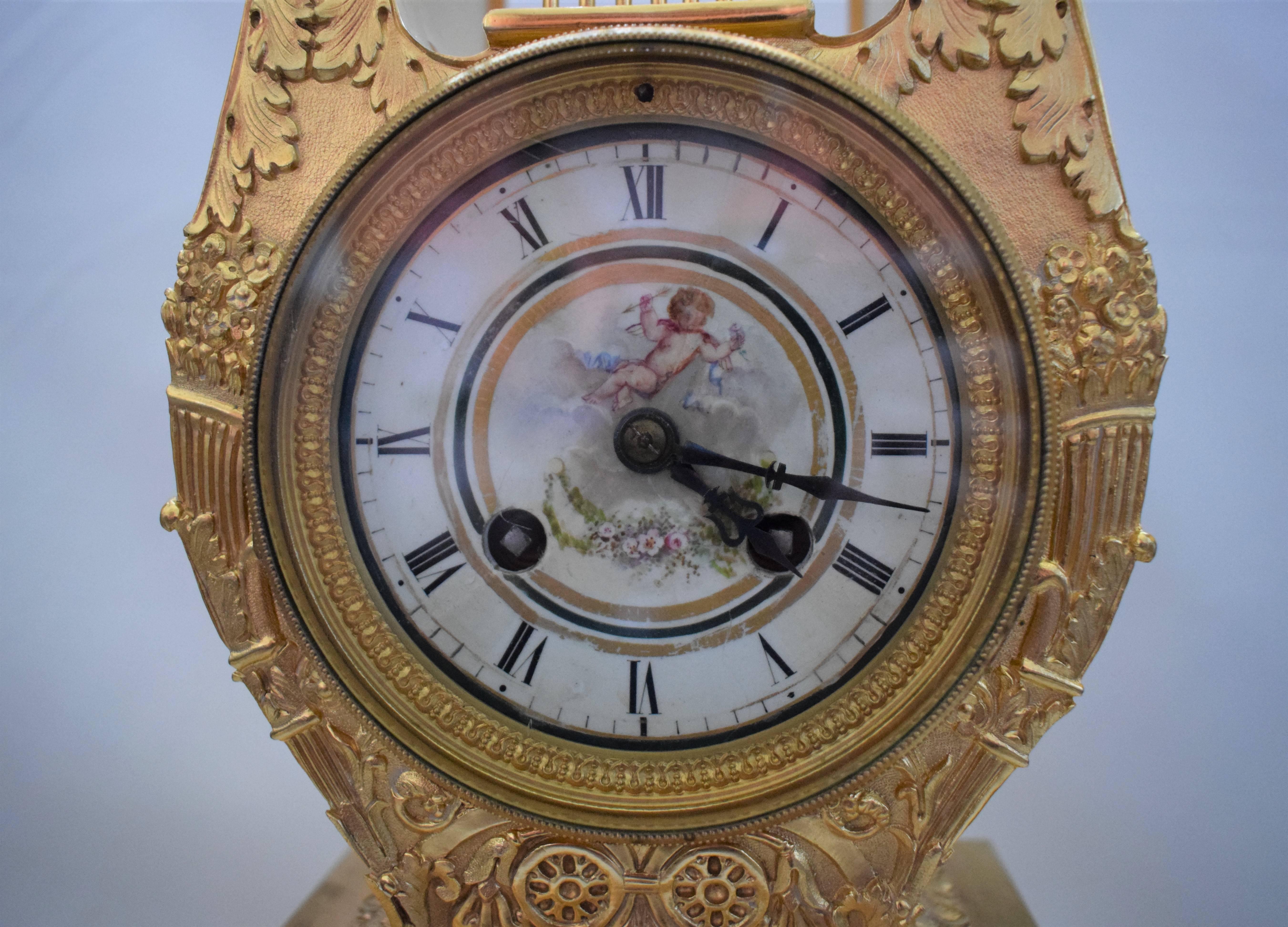 A very beautiful French mantel clock set comprising a central clock and a pair of flanking vases. Porcelain panels finely decorated with romantic scenes of a young couple in a country setting. The hand-painted panel below the dial is signed: