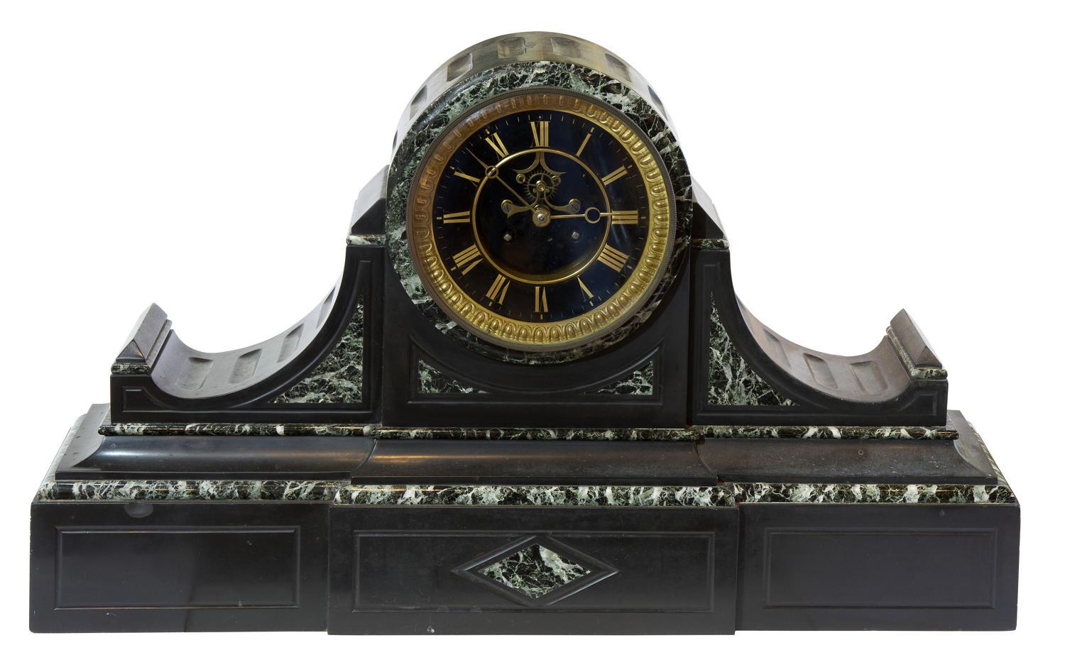 A monumental French mantel (fireplace) clock of month duration with open escapement in a polished slate and variegated green marble case of drumhead form.,

circa 1870.