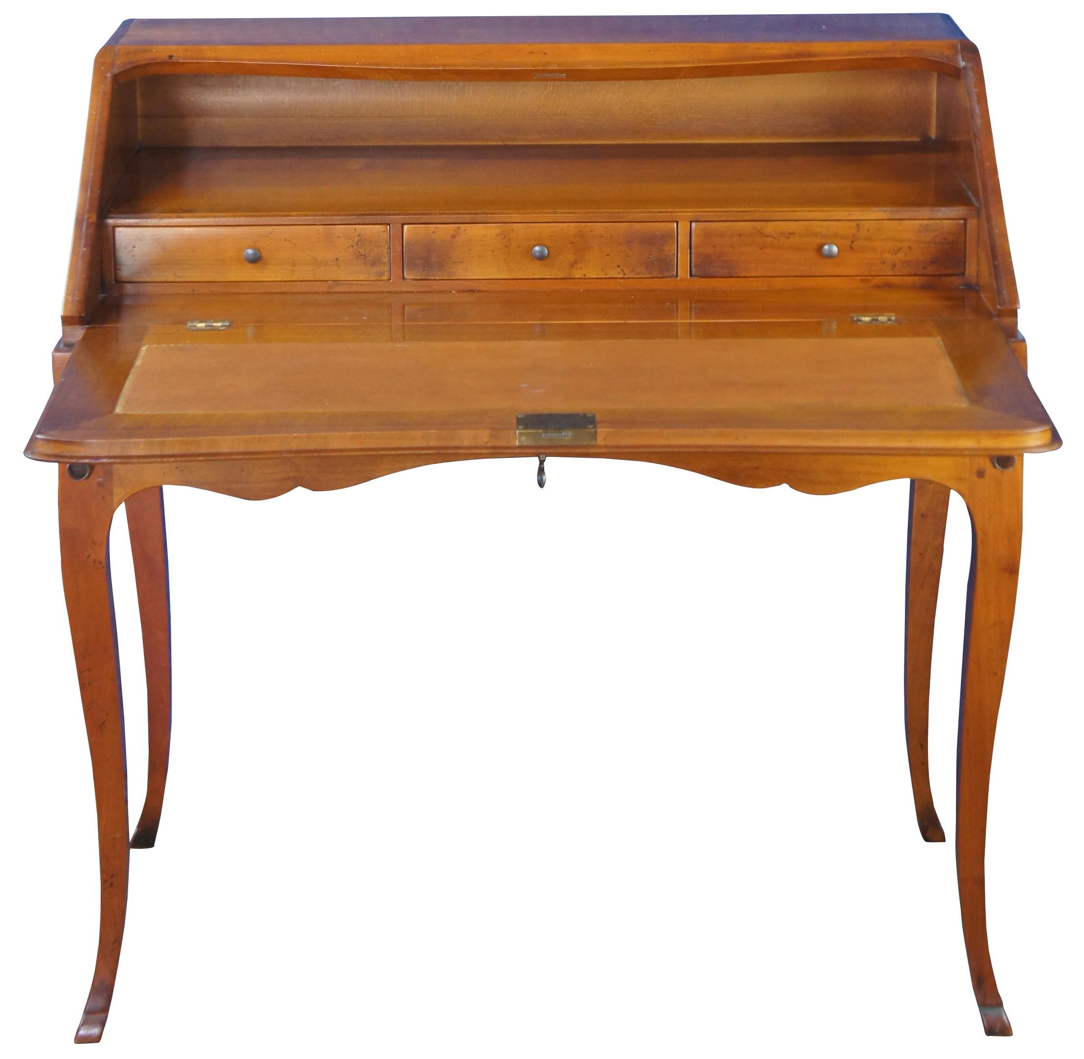 A magnificent 20th century French Provincial Bureau De Dame. Burea de Dame translates to ladies office. A writing desk that is often petite yet functional. Made of maple with a serpentine form and lockable drop front featuring a book or music rest