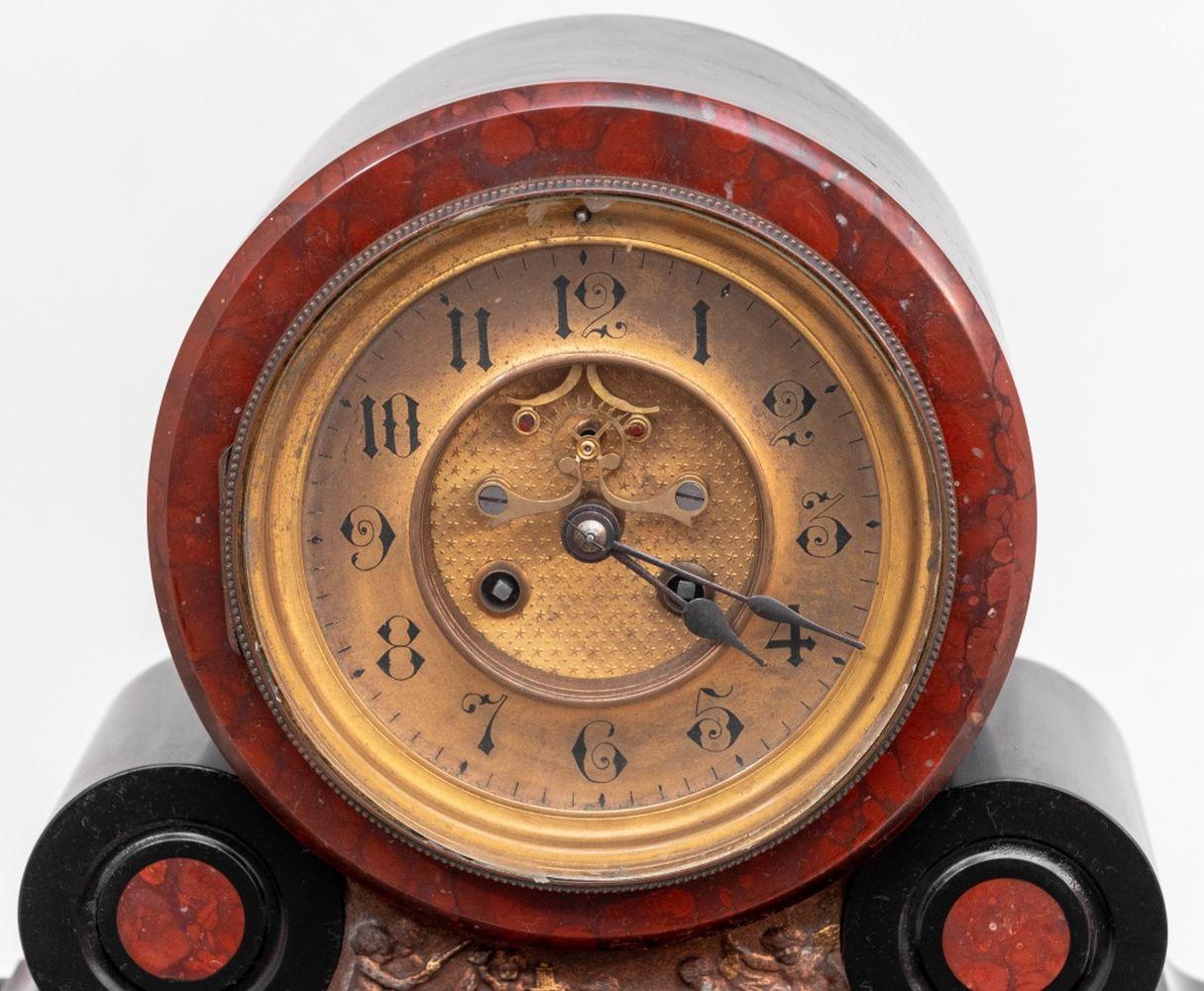French Gilt Metal Mounted Rouge Griotte Marble and Black Slate Mercury Compensated Mantel Clock, late 19th century, the circular brass dial with open escapement, the movement strike on bell. 19.25