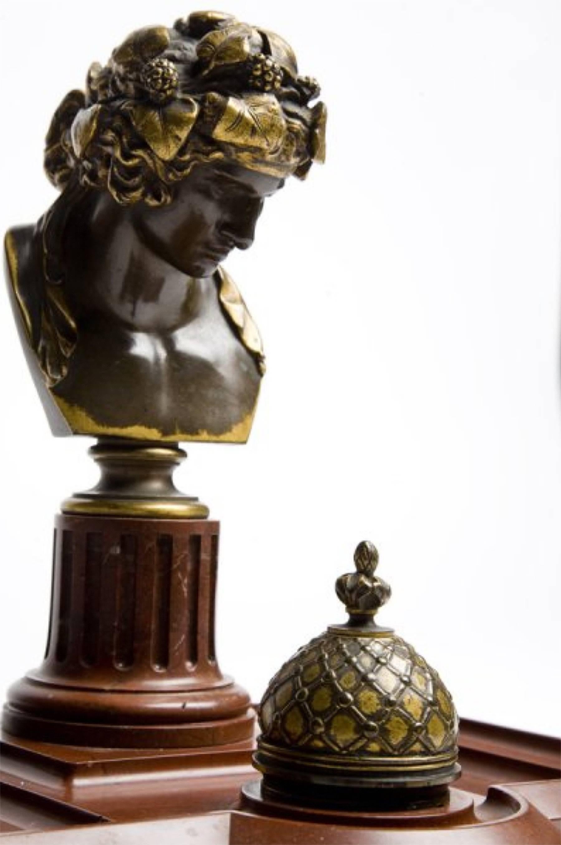 A Verona red marble remarkable inkwell, pure Empire style representing a gilded bronze of the bust of Antinous as Dioniso. Empire style, France. Signed by Ferdinand Barbedienne foundry.
Generous size, excellent state of preservation.