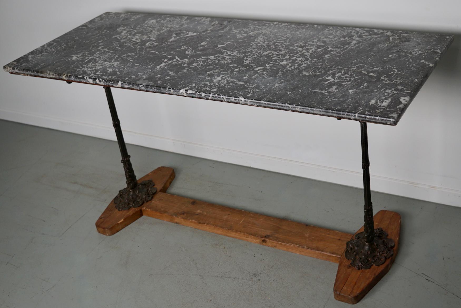 This French console table was designed and made circa late 19th century from marble and cast iron. It remains in a very good condition. It can be used as a display table in a shop or as a side table. The legs are now mounted to a wooden base but