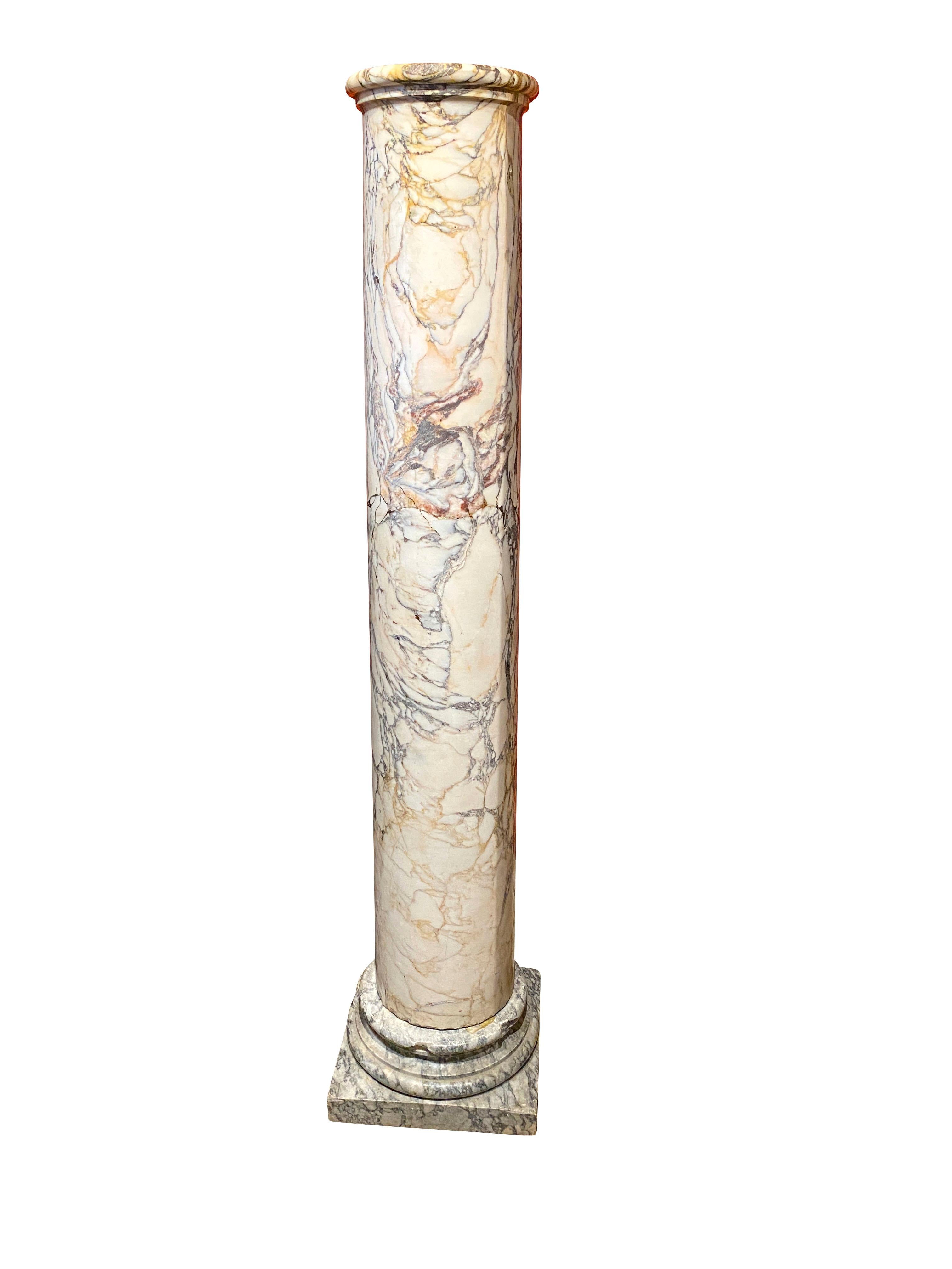 The tall column sitting on a socle with square base.