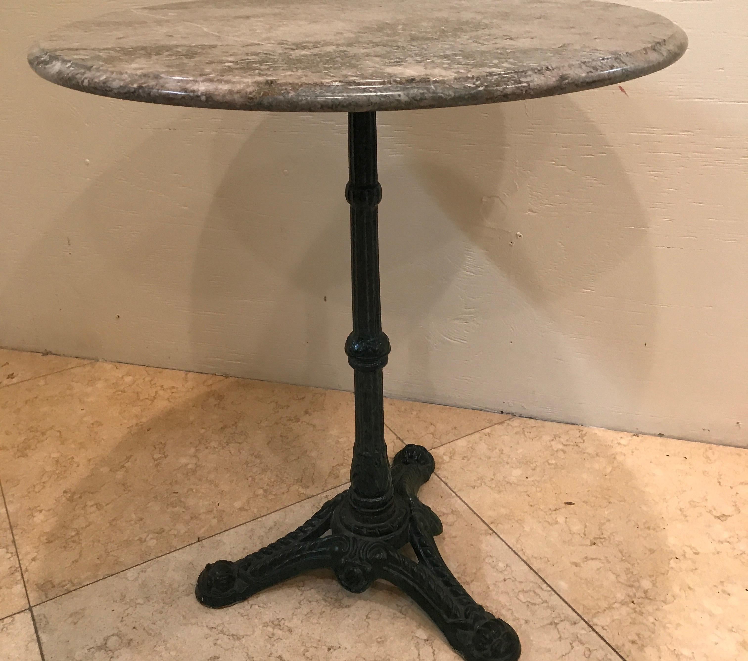 Parisian bistro table with marble top and cast iron base.