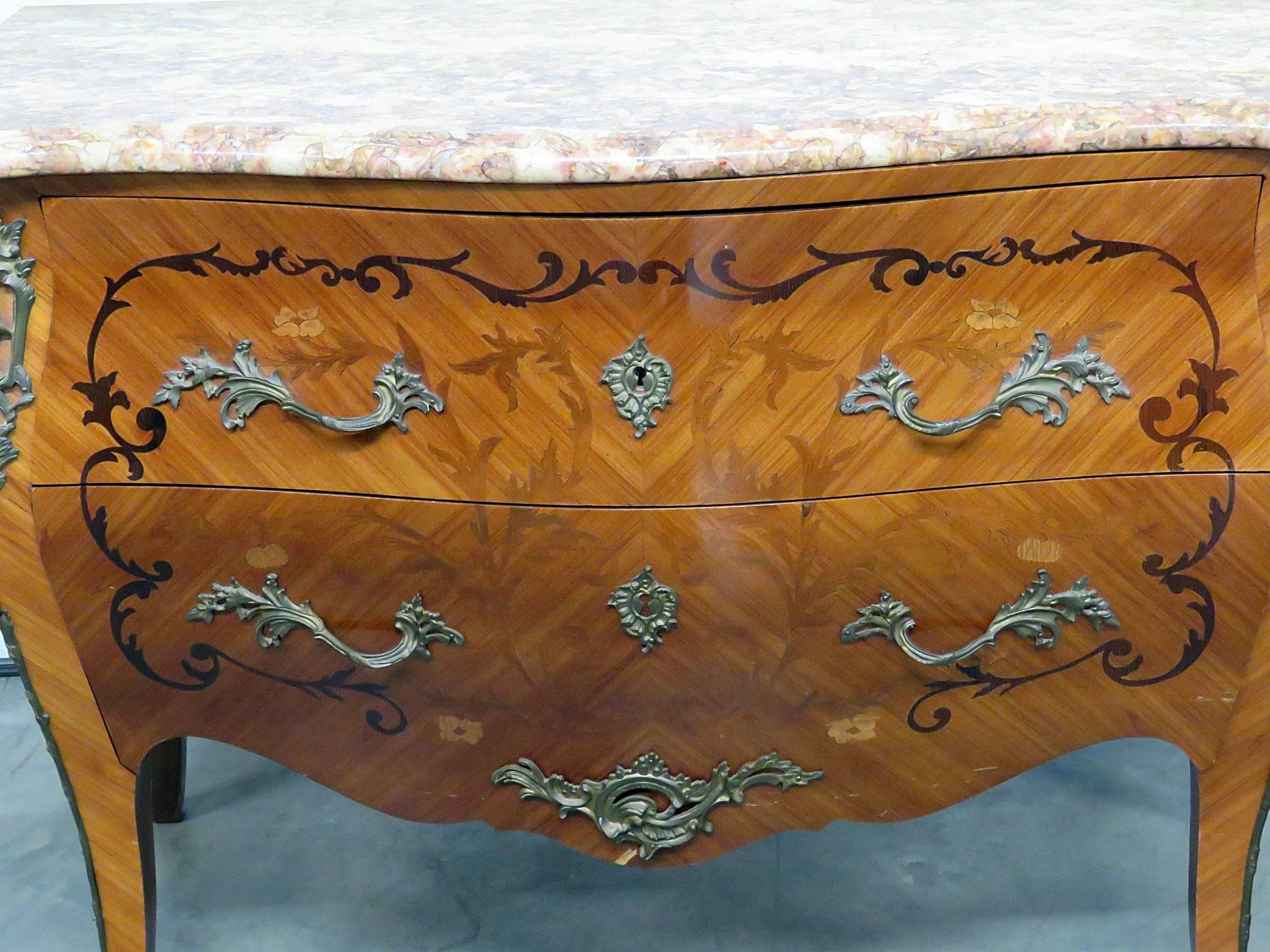 French marble-top bombay commode with two drawers, intricate inlay and bronze accents.