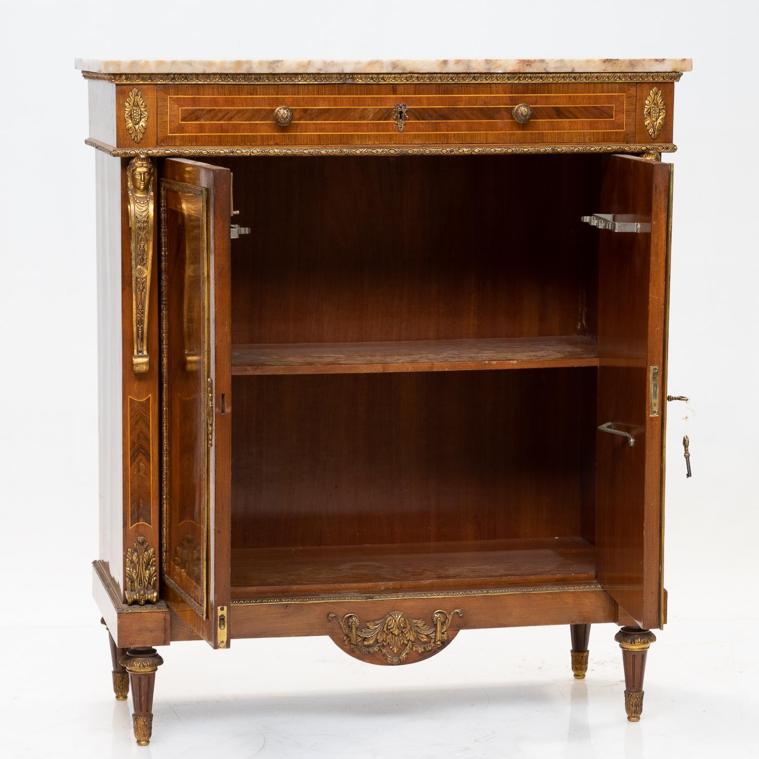 French marble-top cabinet with figured mahogany, walnut and kingwood bandings, some satinwood inlays. There are gilt bronze mounts. The gilt bronze mounts have natural wear to the gilt, which gives them a nice original look. The marble top is