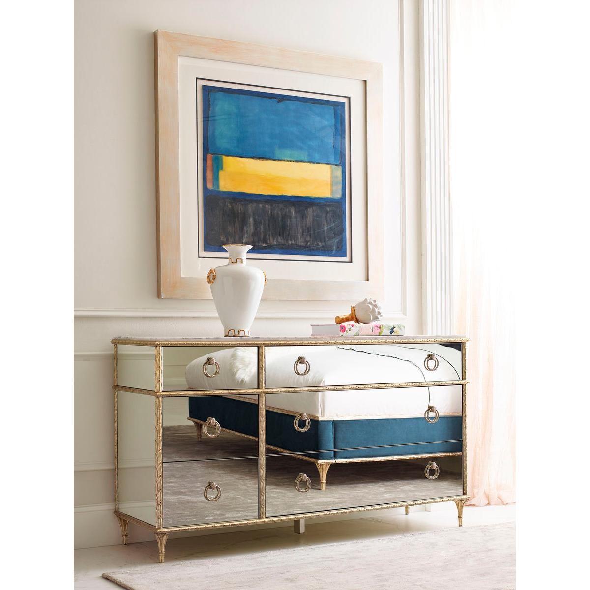 This dresser offers a stunning fusion of form and function, measuring generously to accommodate a wide array of wardrobe essentials.

The dresser features mirrored front and end panels, creating a dazzling reflective surface that enhances the light