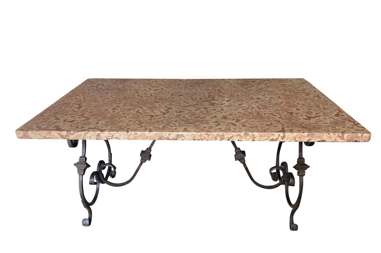An outstanding Garden Dining Table from the Provence region of France.  Beautifully constructed with an exceptional marble top and a stunning iron base.  Perfect for any interior or garden.