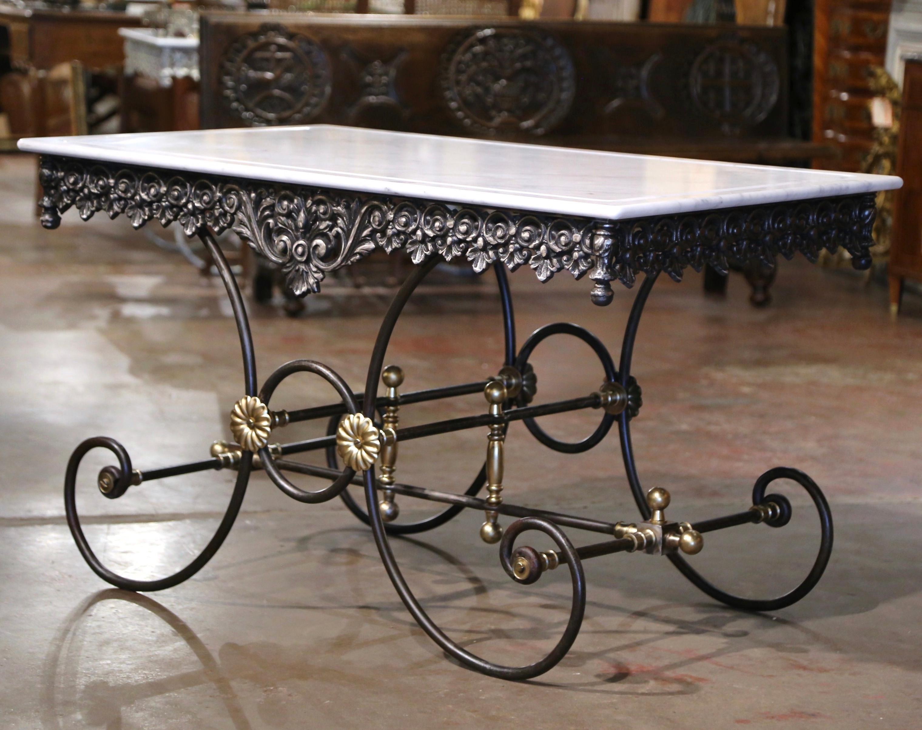 This large pastry table (or butcher table), would add the ideal amount of surface space to any kitchen. Crafted in France, the table stands on four scrolled legs over an intricate stretcher and decorative bronze rosettes and finials. The table