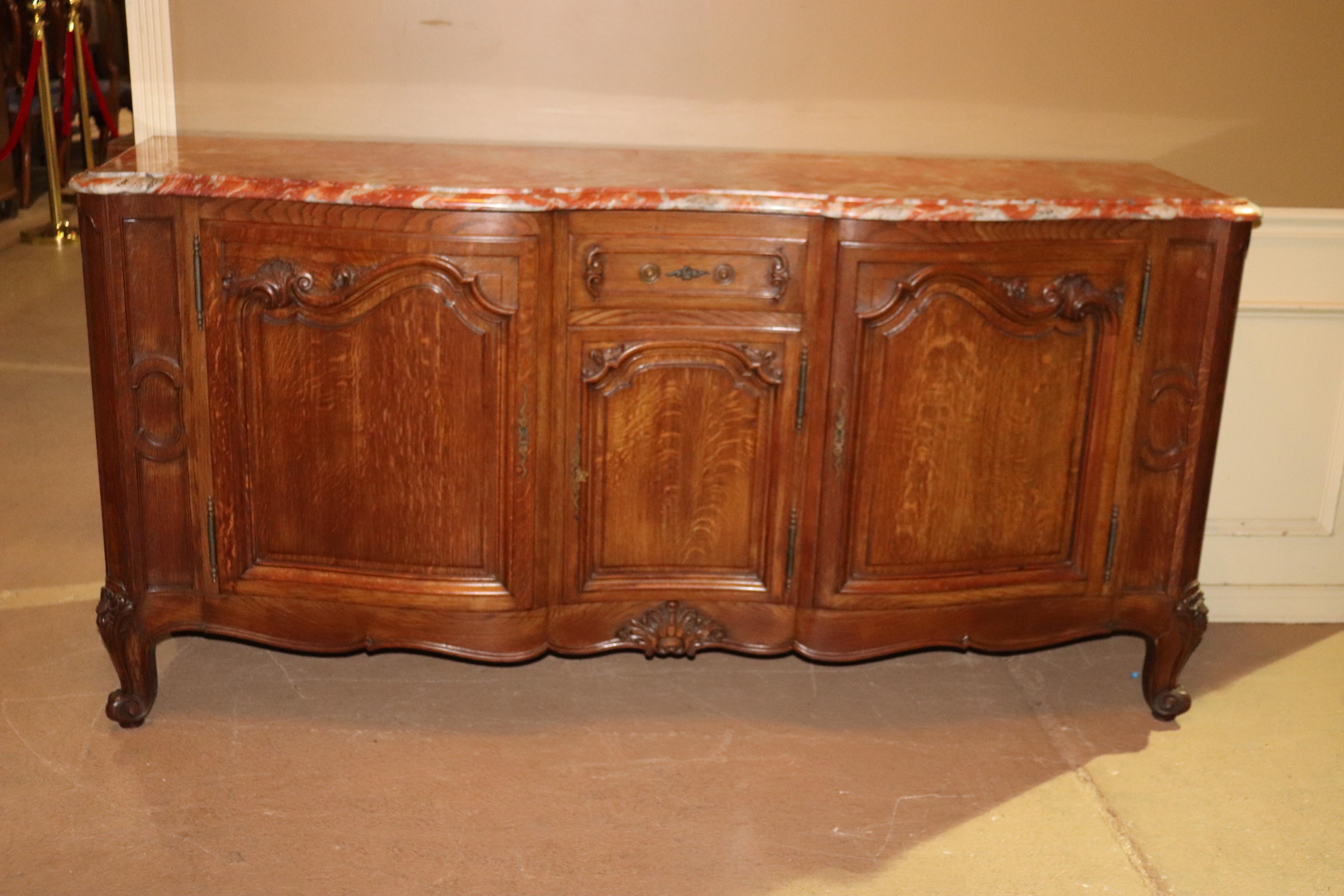 This is a superb example of fine French craftsmanship. Look at the fantastic marble top and gorgeous tiger oak case. The bail-pull will be installed when the piece is delivered. The piece was shot without it but we have it and will put it on for
