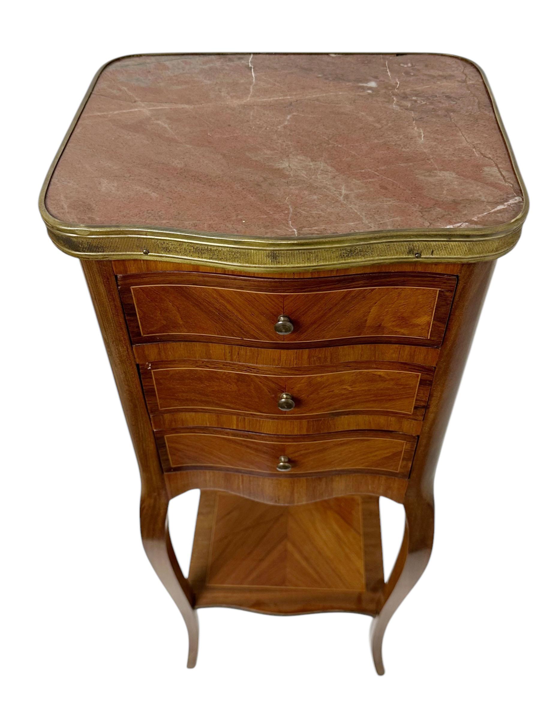 A 19th century French side table with rouge colored marble top and a bronze gallery. There are three drawers. Circa late 19th century. 