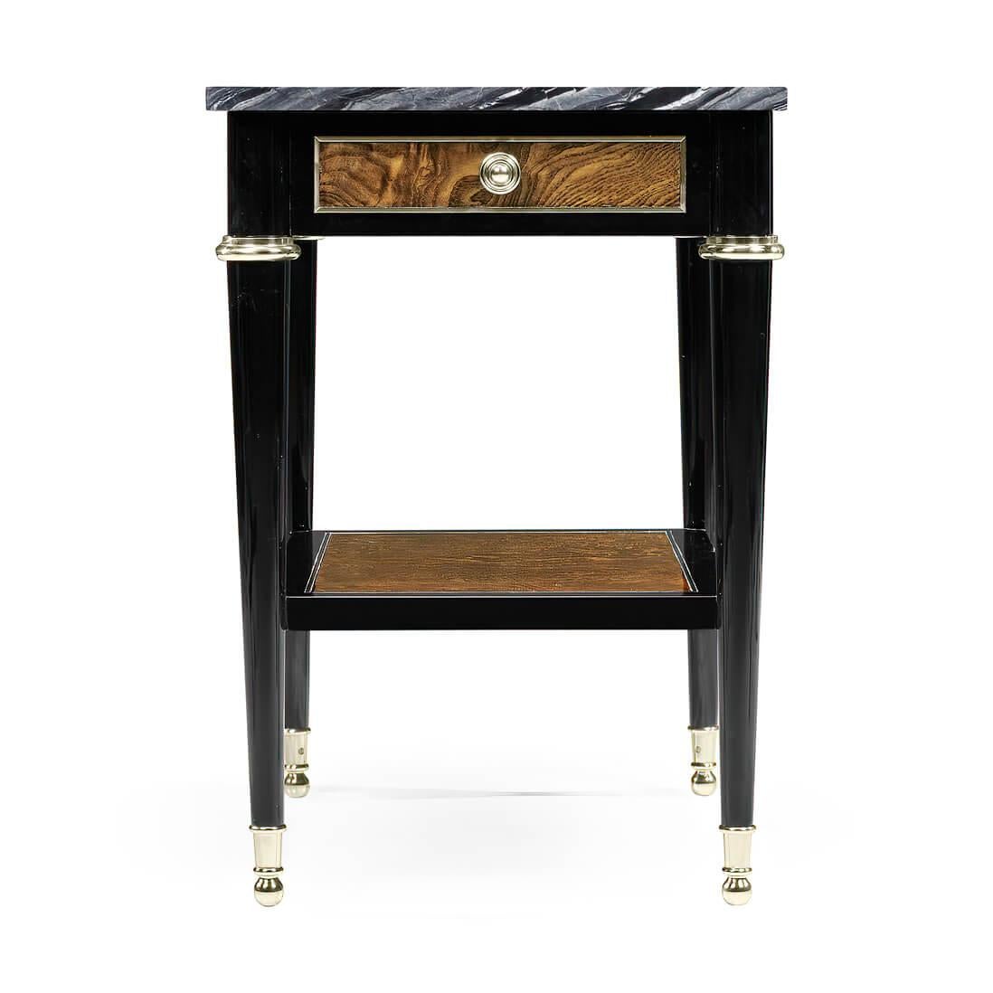 A French Louis XVI style, modernized, black lacquered and amber ash burl paneled side table with a rare variegated grey marble top, single drawer with brass pulls and capitals, a lower shelf stretcher and turned and tapered pegs raised on ball foot