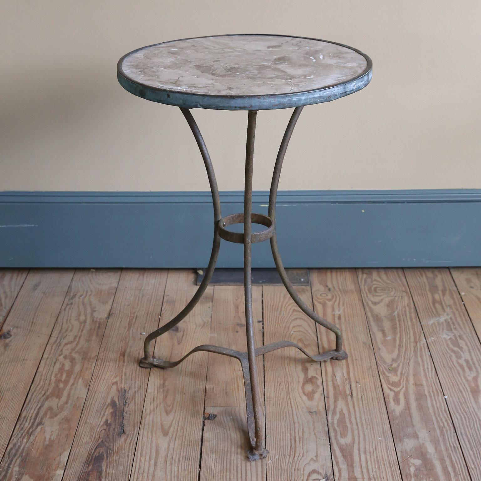 This Classic French Gueridon was used in a bistro. The color of the marble is interesting. The base is original iron. There is wear of the feet. Please notice in the photos. The table is equally nice for interior or exterior use. It is iron so will