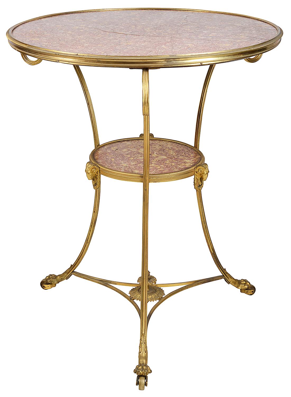 A very elegant late 19th century French gilded ormolu Gueridon, having a wonderful inset Rosa marble top, three scrolling out swept supports, an under tier also with a matching inset marble, Rams head and wreath mounts, terminating in classical claw