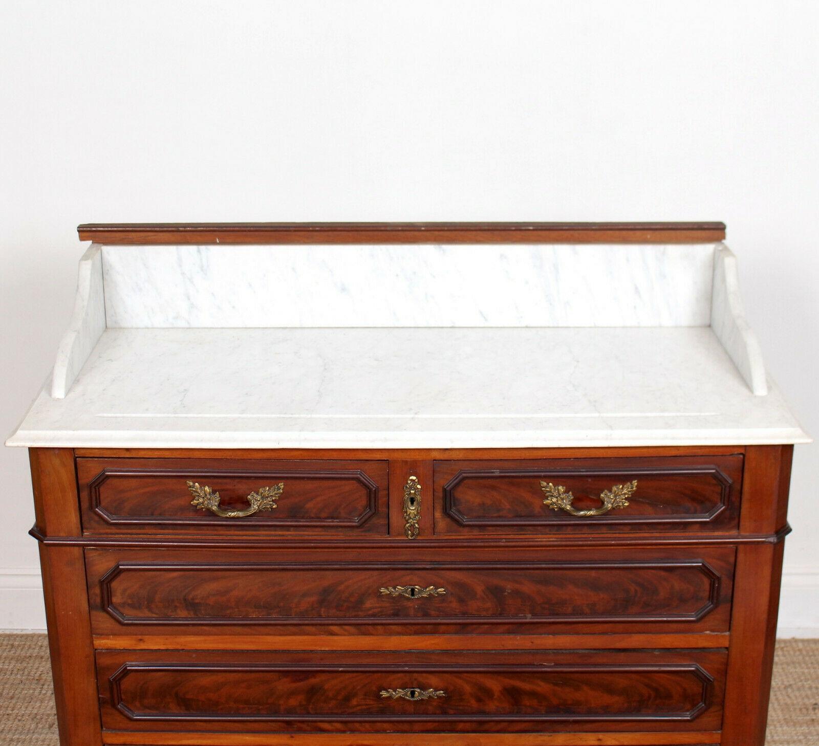 19th century French marble and Cuban mahogany washstand.

The marble top above an arrange of beadwork paneled short and long graduating drawers with oak lined interiors and dovetailed jointing.
Raised on a plinth base with canted corners and