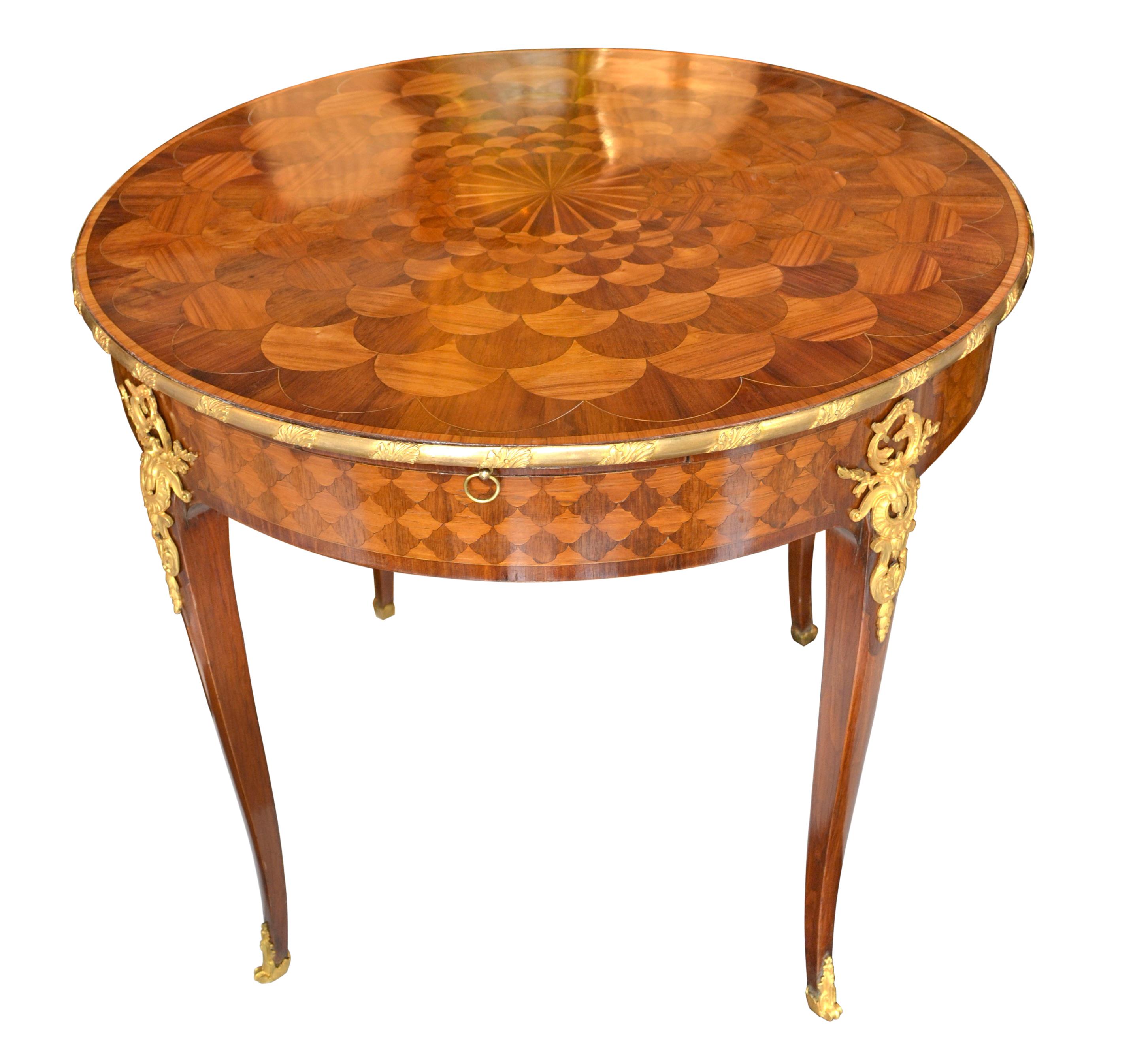 A Louis XV style 19th century French centre or games table, the quality of which could be attributed to the Linke workshop in Paris. The table is completely veneered in various woods including tulipwood and amaranth with the top inlaid in a