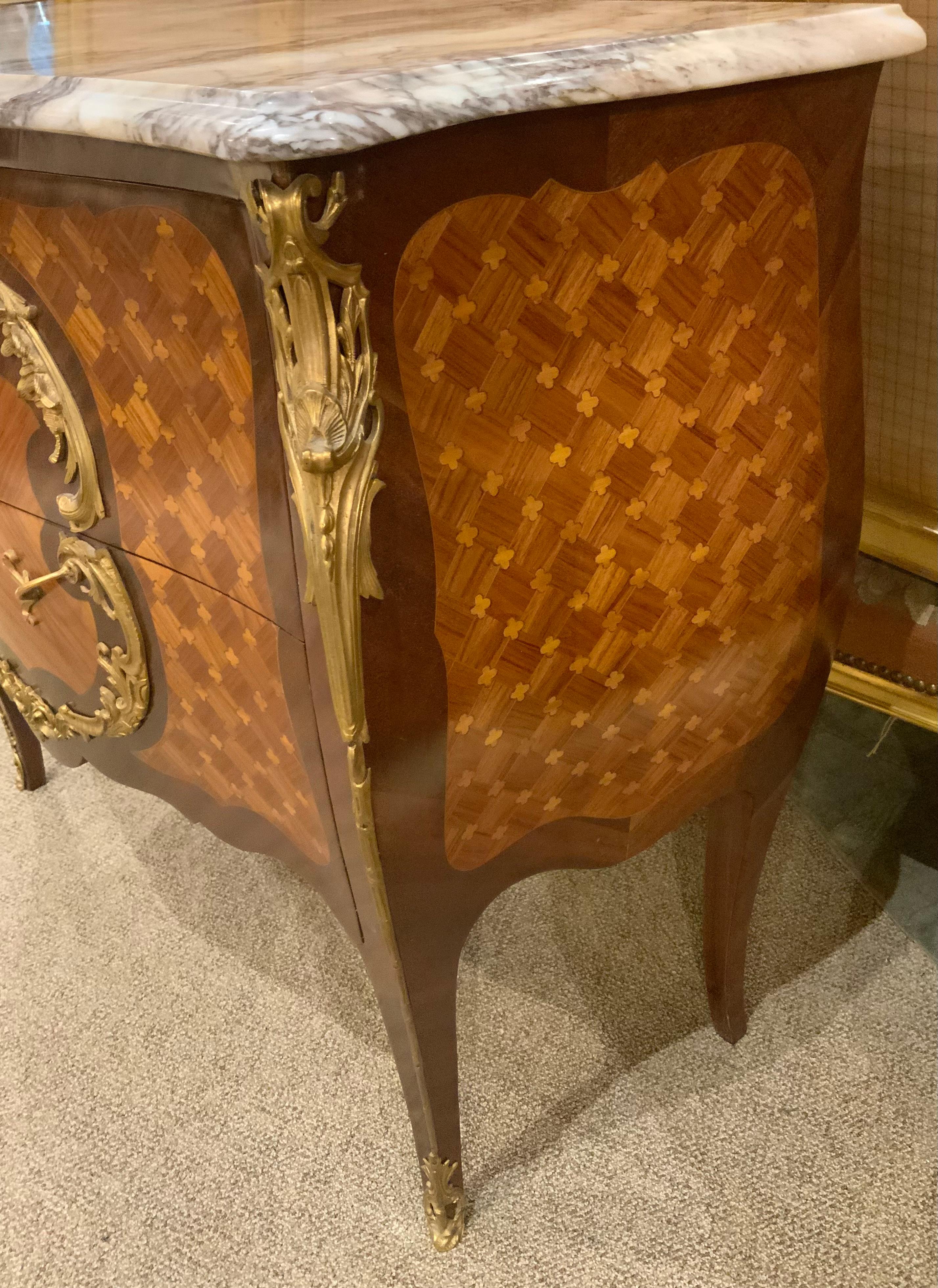 The fine workmanship demonstrated in the fine marquetry 
Makes this piece especially fine. The bronze mounts are
Well cast and have a brilliant gilt hue. The shaping of this
Piece is graceful with curved sides in a bombe form.
The color of the