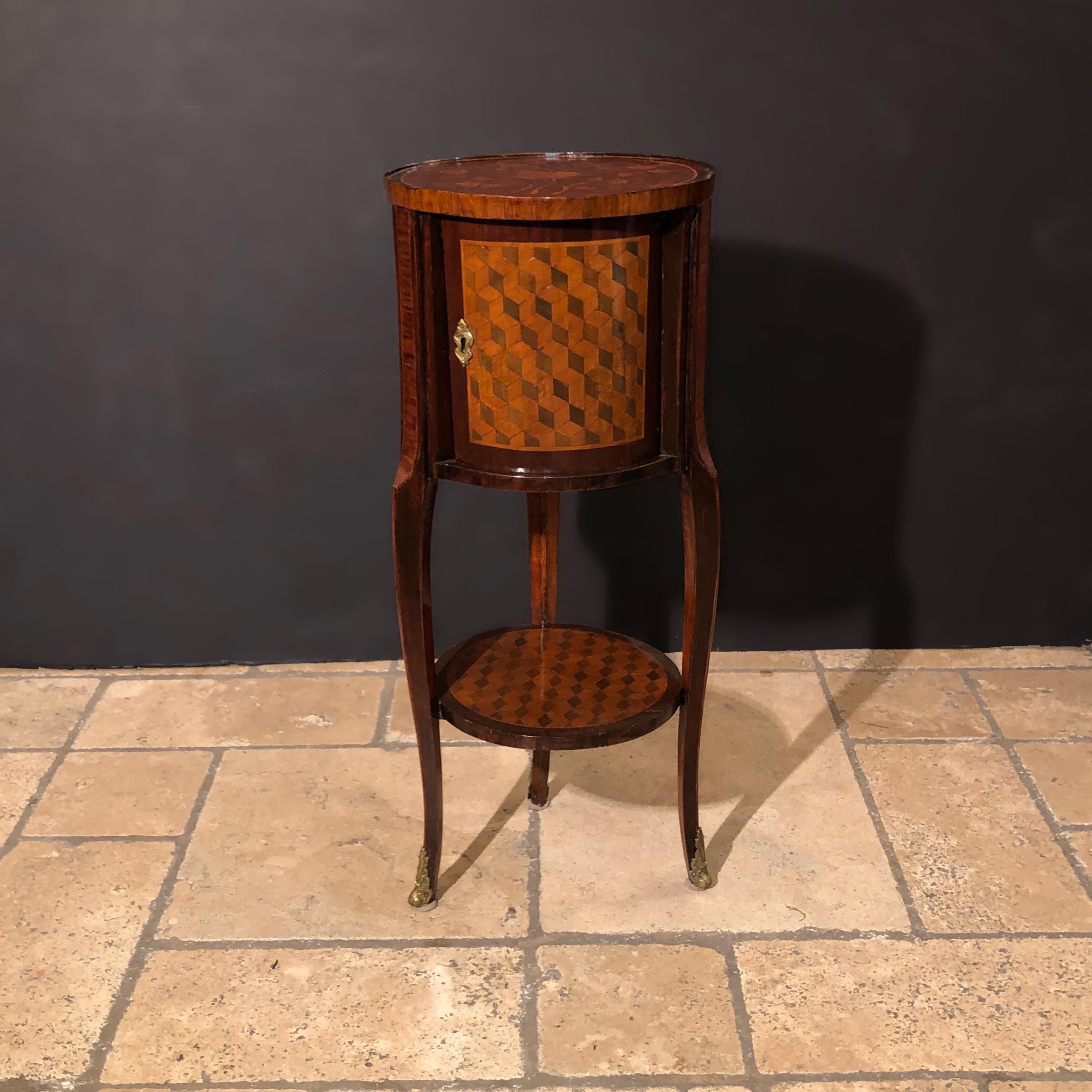 French transitional Louis XV / XVI marquetry and parquetry inlaid cylinder form three-legged side table with sliding door and a fitted three drawer interior, with cabriole legs, a shelf stretcher, and bronze sabots.