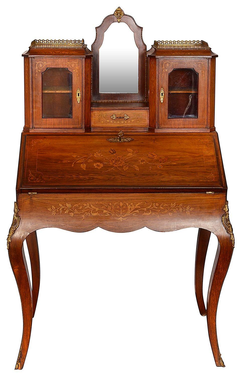 A good quality late 19th Century French Rosewood inlaid Bonheur Du Jour, having glazed cupboards and mirror above. A fall front bureau opening to reveal compartments within, drawers and an inset leather writing tablet. Raised on elegant cabriole