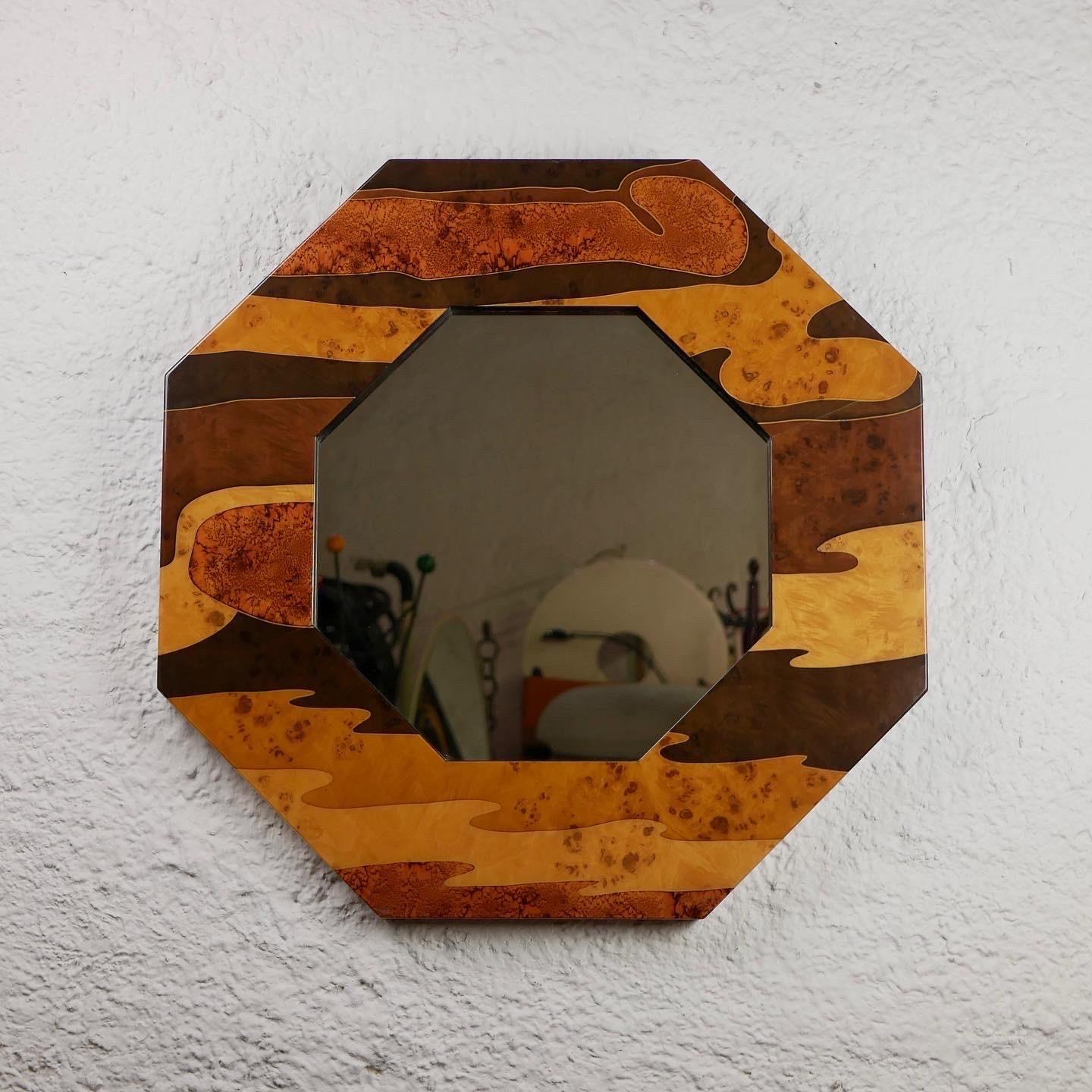 Beautiful and rare octogonal mirror by Jean-Claude Mahey for Romeo, made in France in the 1970s.
Made in wood marquetry, lacquered. 
Very good condition.