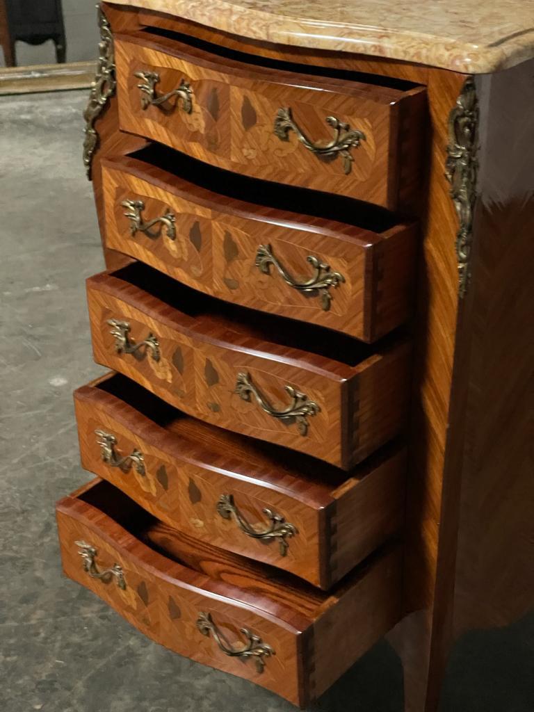 A superb quality French Taller Chest of Drawers. Stamped by a French Cabinet Maker and dating to the 1920s. Having original marble top in excellent condition and ormolu mounts. Made from Kingwood with inset marquetry. All the drawers run
