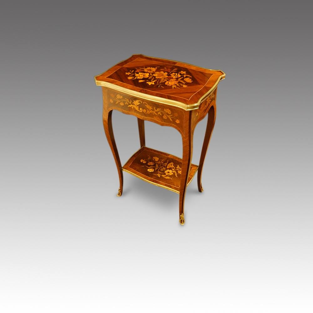 French marquetry side table 
This French marquetry side table was made circa 1910.
The top with the large panel of floral marquetry and of serpentine shape.
It stands on cabriole legs finishing with a gilt brass mount at the toe.
It has an oak lined