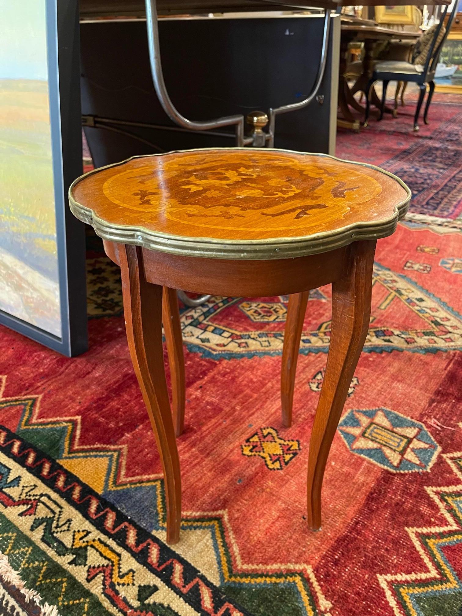 French Marquetry side table with a brass Trim around wood top, 20th century.
    