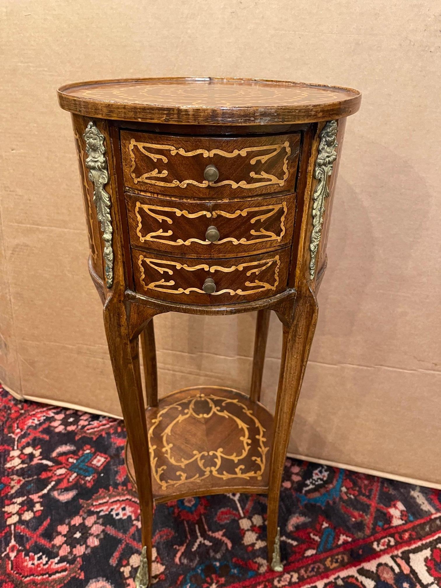 French Marquetry side table with three drawers, wood gallery, and brass Escutcheons, 20th century.
    