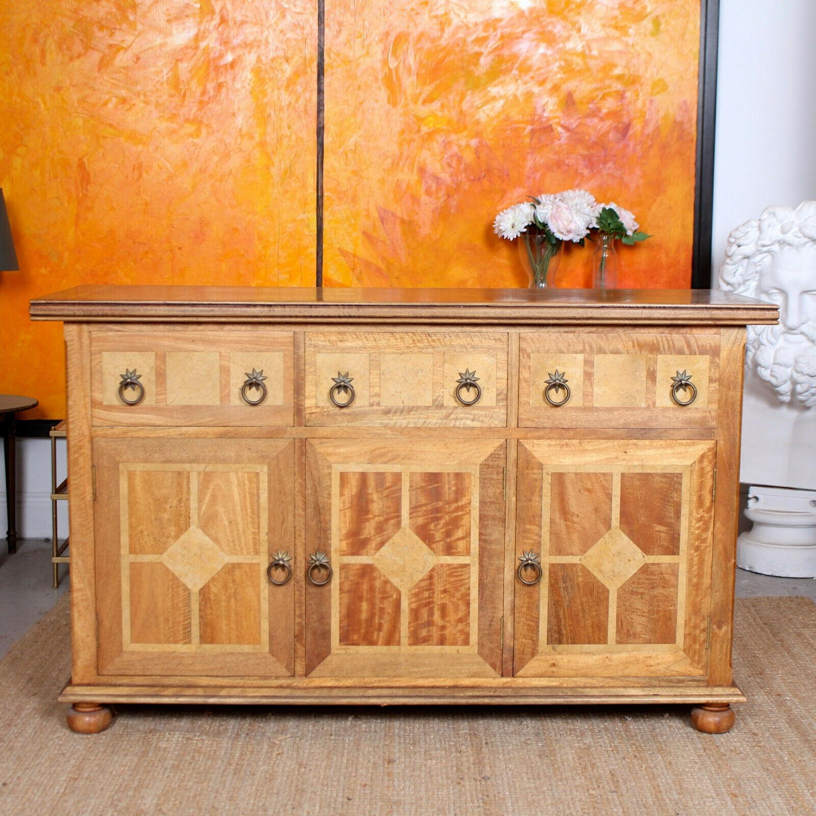 An impressive vintage French credenza.

Boasting fine quality exotic wood marquetry inlays throughout and carved reeded edges. The drawers and the doors mounted with excellent brass handles . The drawers with solid interiors and dovetailed
