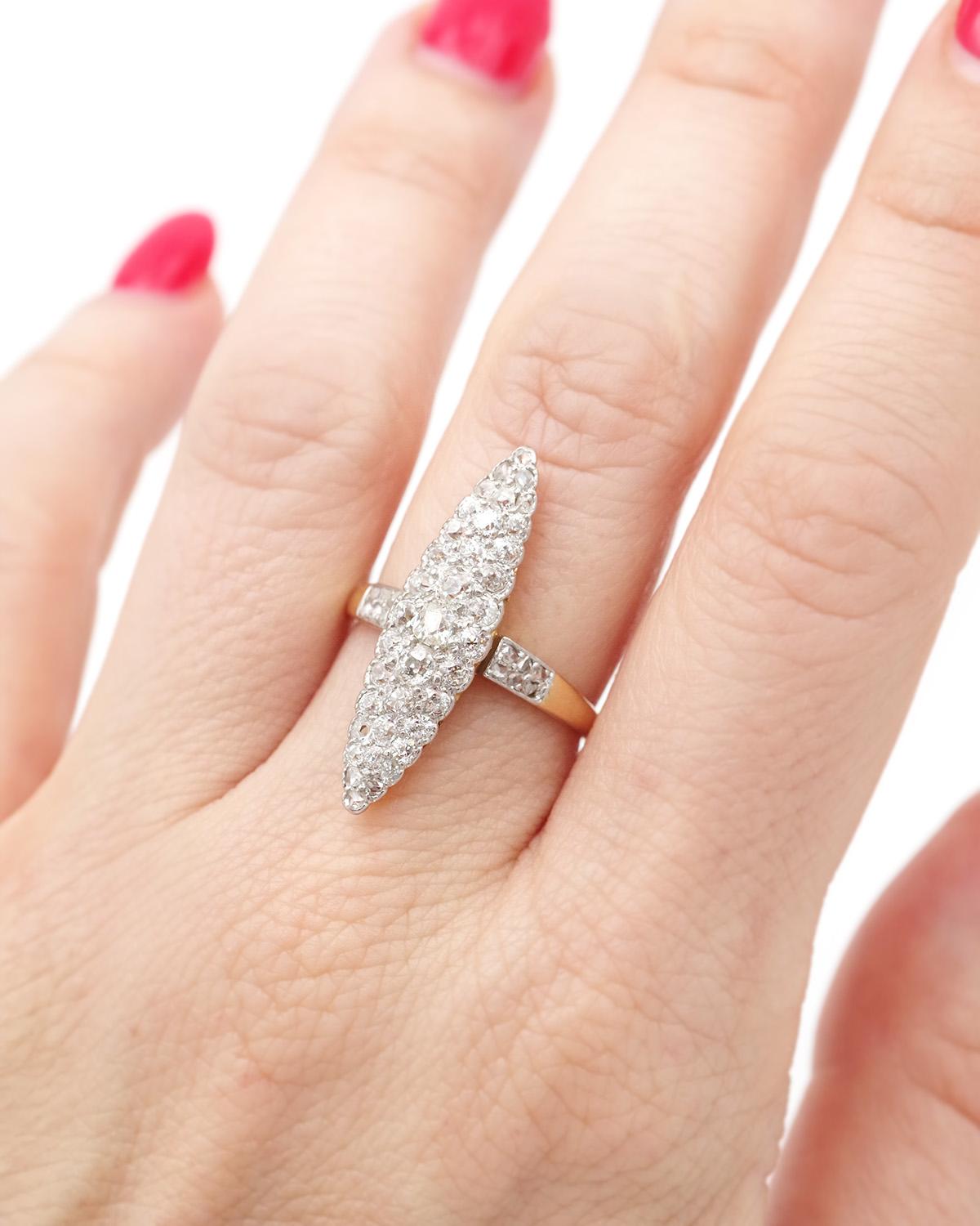 Marquise navette diamond ring in 18 karat gold and platinum, set with 37 old-cut and rose-cut diamonds. The diamonds weigh a total of 1.17 ct. The shoulders of the ring are adorned with rose-cut diamonds. Belle Epoque ring, early 20th century.

Mask