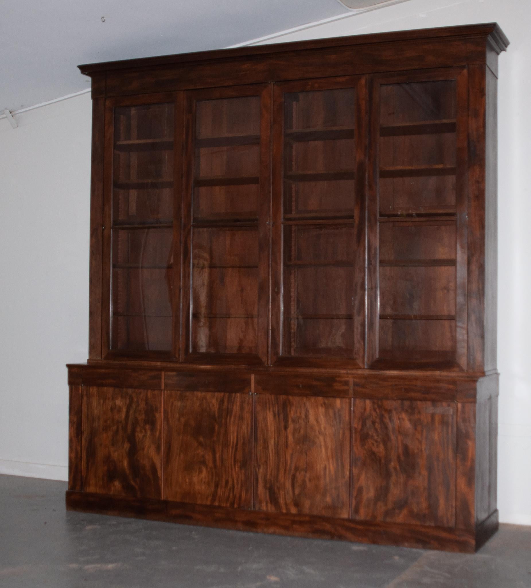 This fabulously large bibliotheque was crafted in France in the 1800s and provides a great amount of shortage space. The top measures 82-¼”“H x 116-½“W x 18-¼”D and houses 5 finished adjustable shelves behind the original wavy glass doors. The