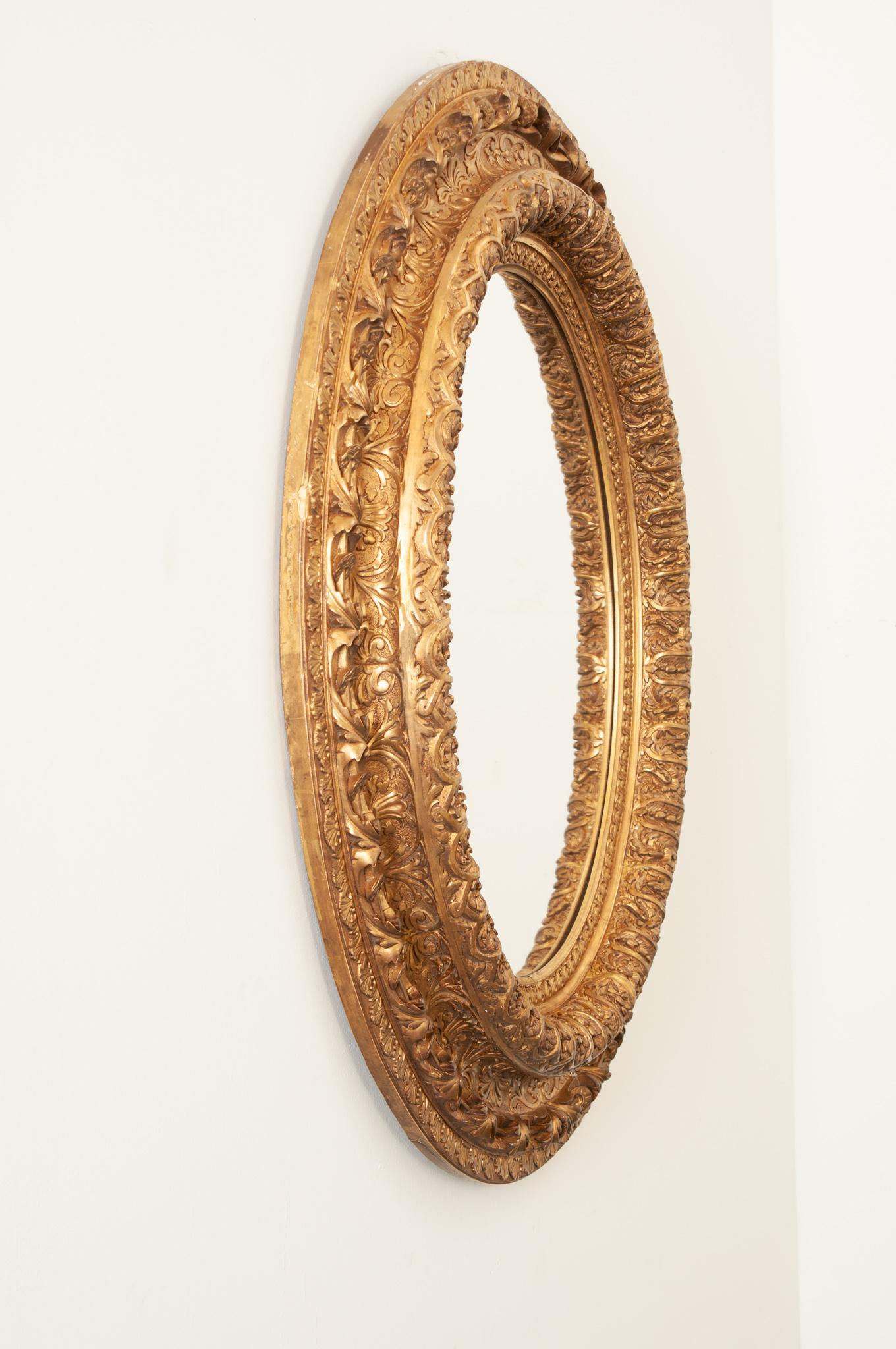 19th Century French Massive Napoleon III Giltwood Oval Mirror For Sale