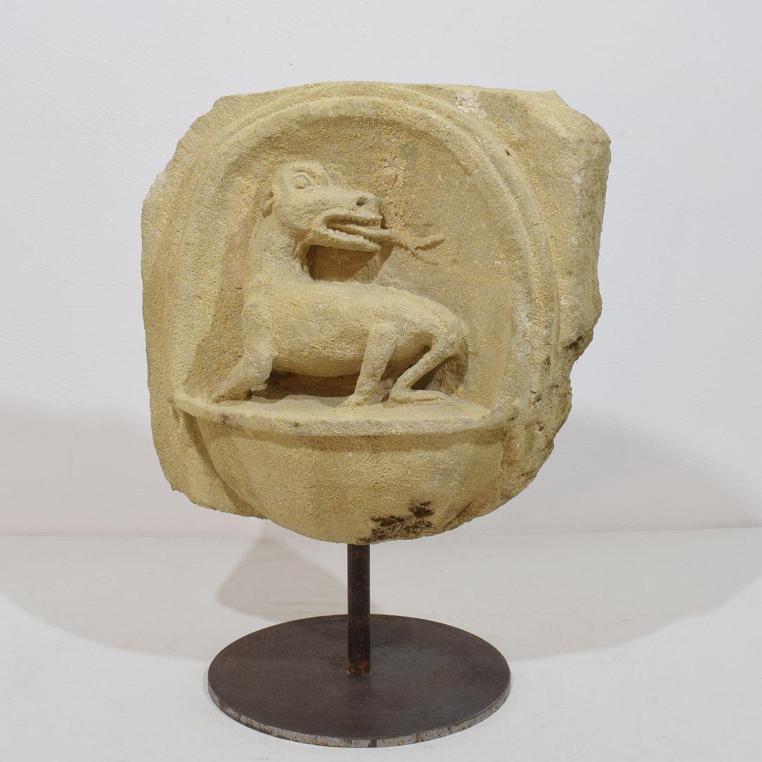 Amazing period piece. Beautiful hand-carved fragment depicting a dragon / mythical creature. Once had its place in wall of a medieval church or chapel in the South of France. Weathered stone full with small fragmented fossils of shells
Placed on an