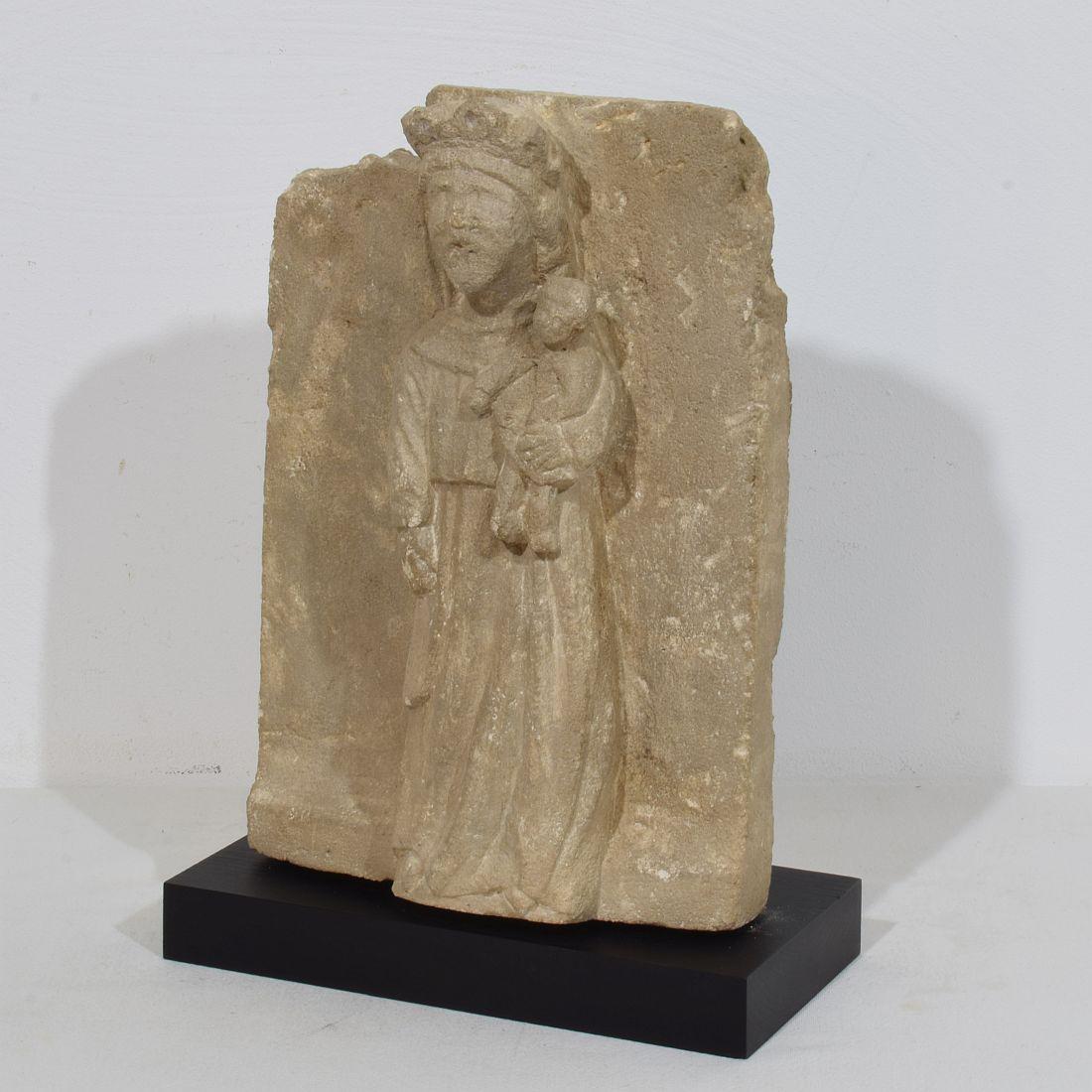 Beautiful primitive medieval stone panel, depicting a Madonna with child
France before 1600
Weathered and small losses