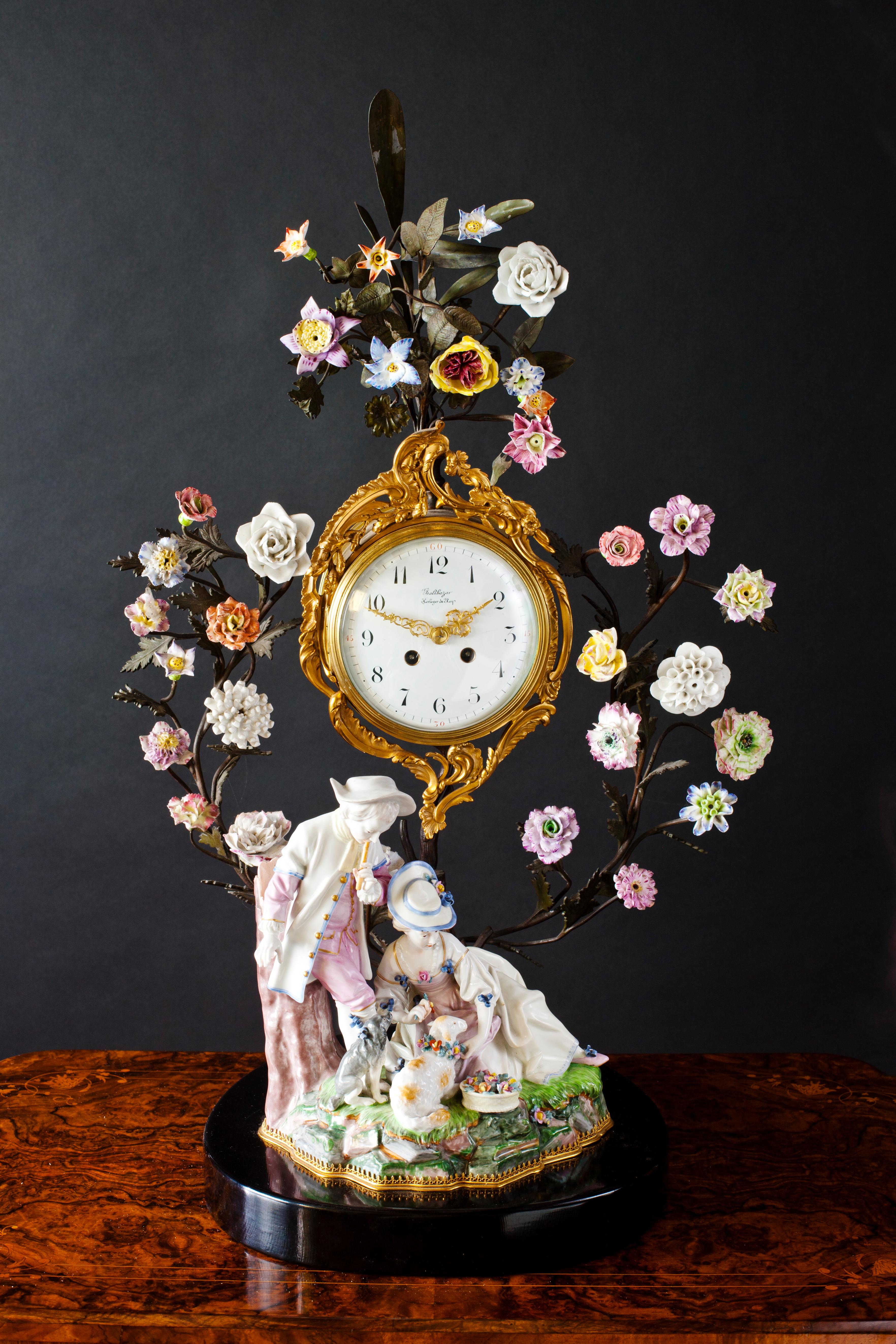 Meissen clock


Meissen Porcelain mantel clock with patinated stem and branches. Displaying a myriad of finely worked flowers. Porcelain study to the foreground of a Gentleman and his lover with their two dogs in a rural scene beautifully