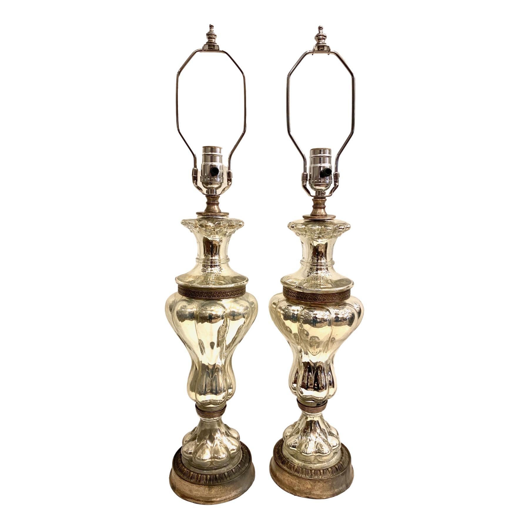 A pair of circa 1920's French mercury glass table lamps with metal bases.

Measurements:
Height of body 17.5