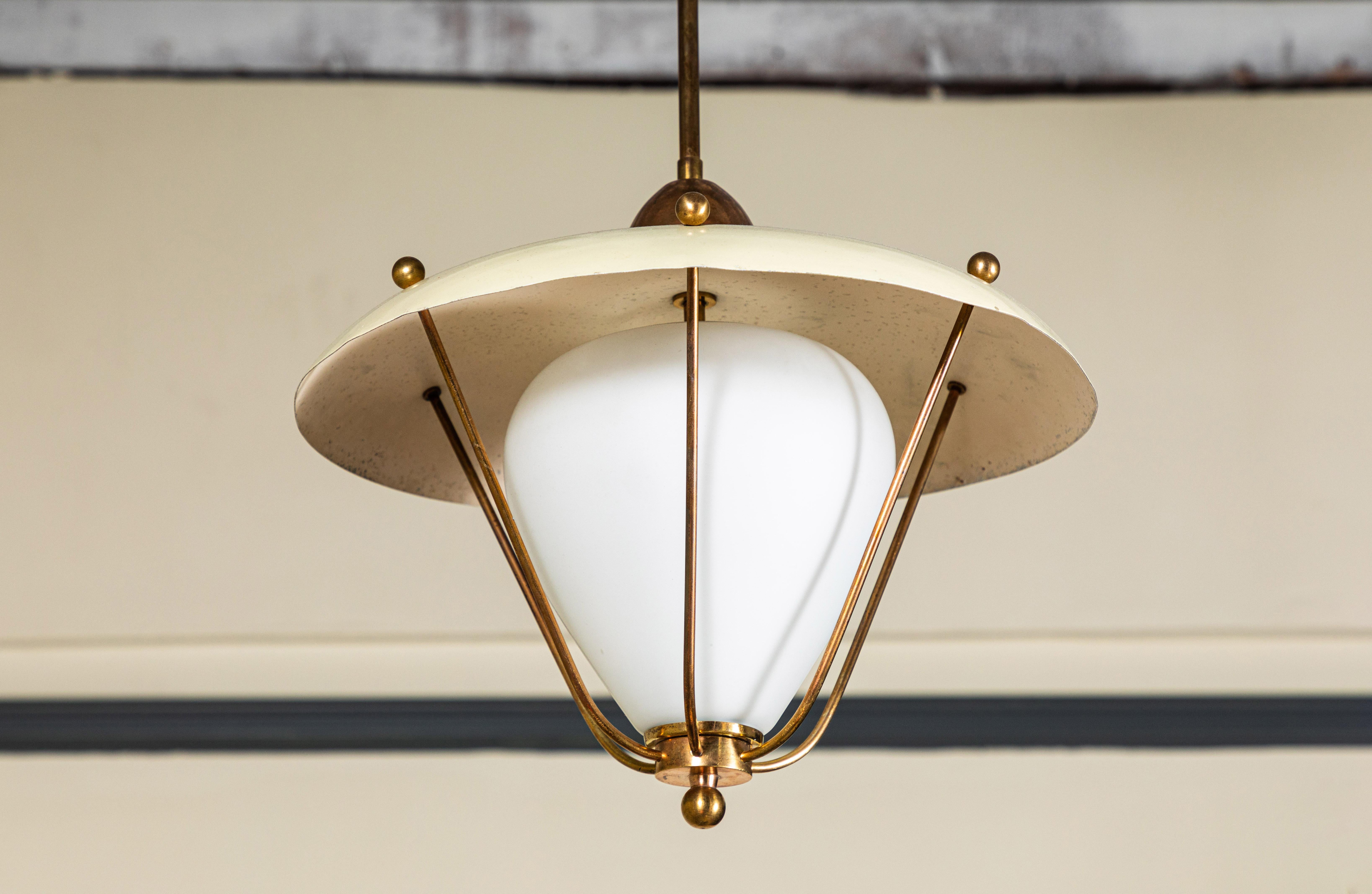 French pendant with beautiful cream colored metal shade with brass details. Simple glass globe adds an elegant detail.

   