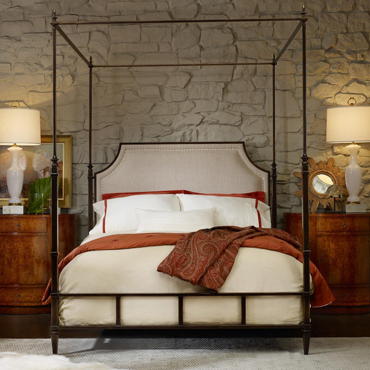French metal canopy bed, queen size, with a bronze finish metal canopy frame with a padded upholstered headboard in a neutral linen fabric. The frame with finials, square posts, and raised on square tapered legs.

Dimensions: 67