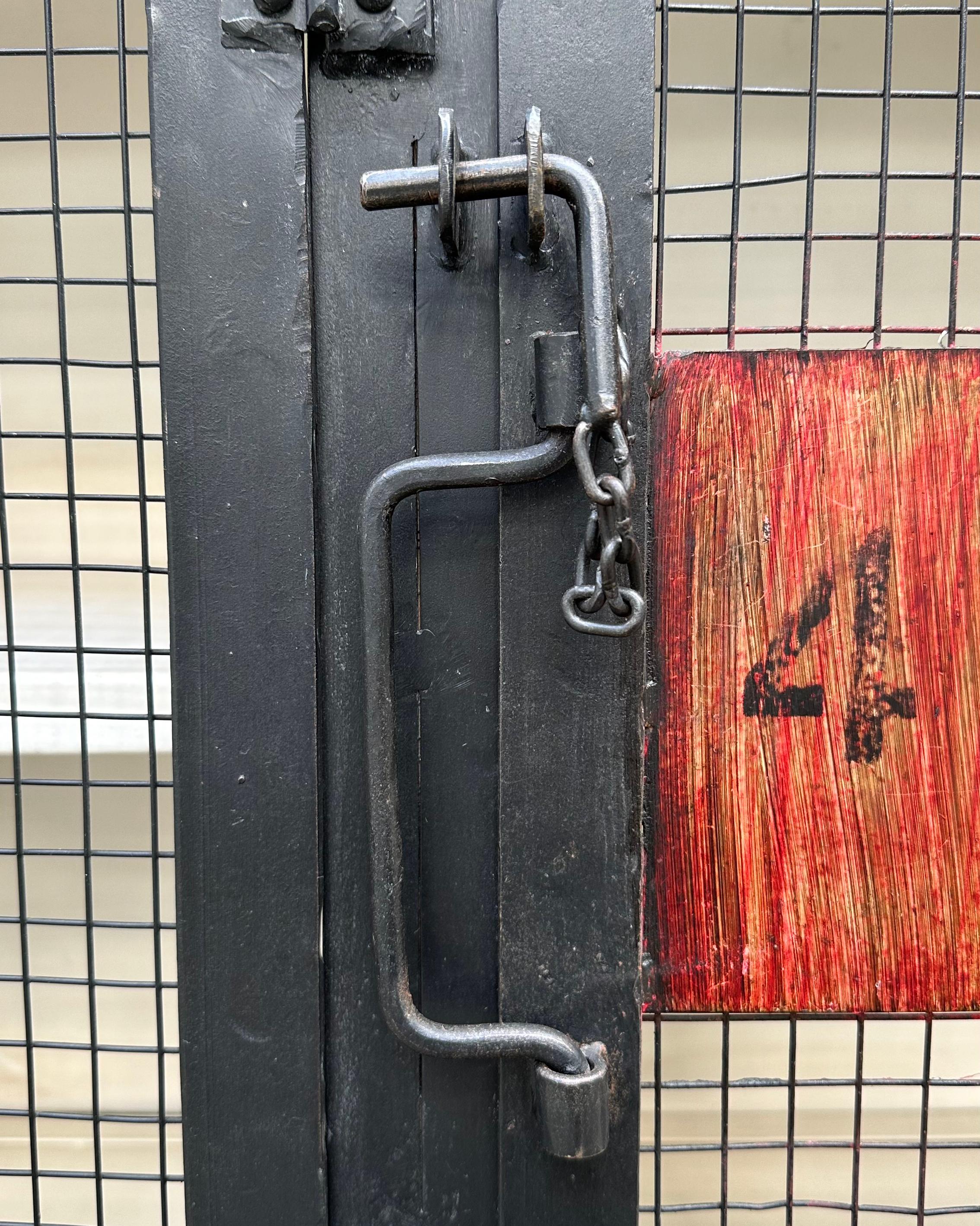 This vintage 20th century French replica metal wine locker features 8 numbered locker doors within a single cabinet. The durable metal construction, finished in black and red, showcases a classic French design, making it a unique and functional
