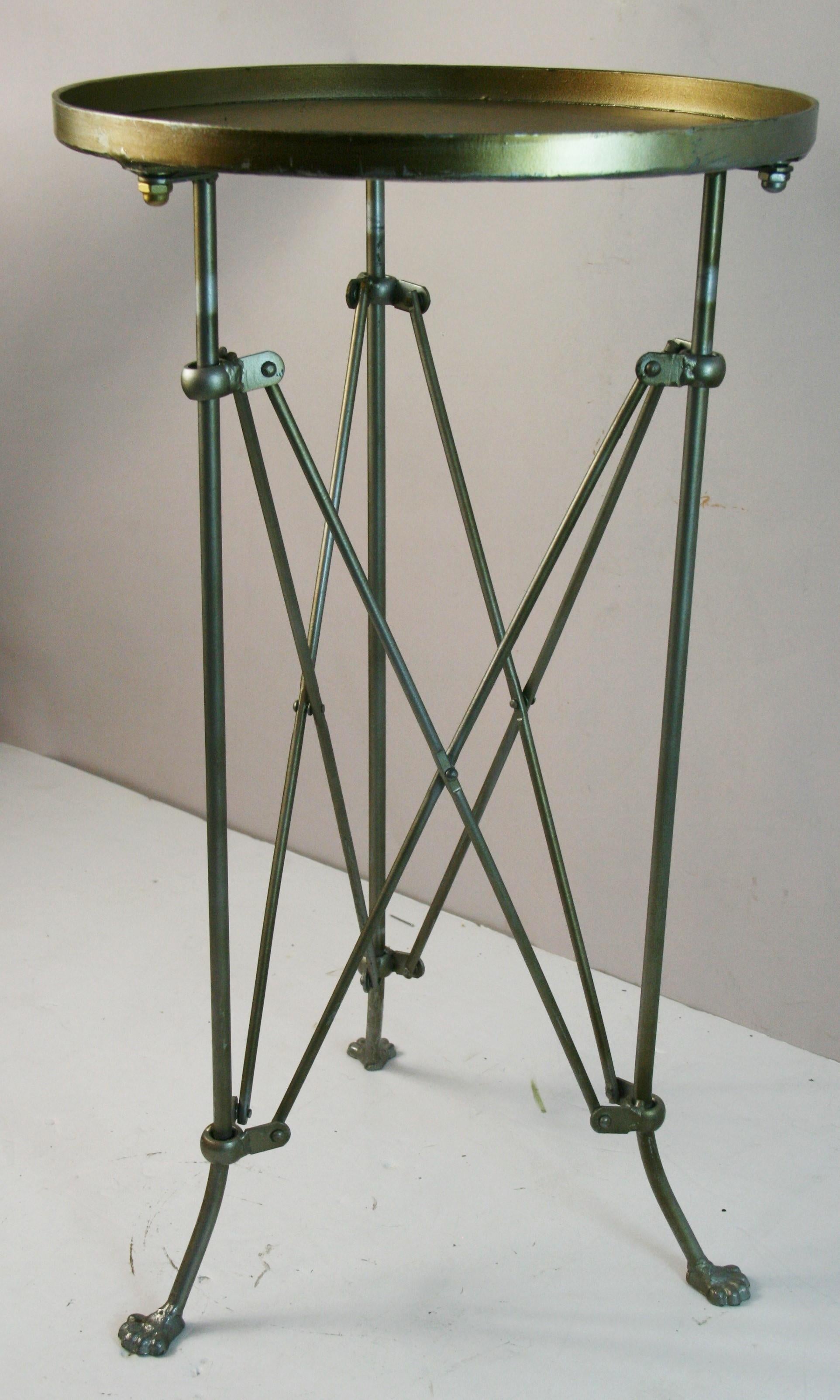 1826 French round  metal side table with tripod legs.
Legs end in paw feet.
Legs have a silvered finish
Top has a gold-silver finish
