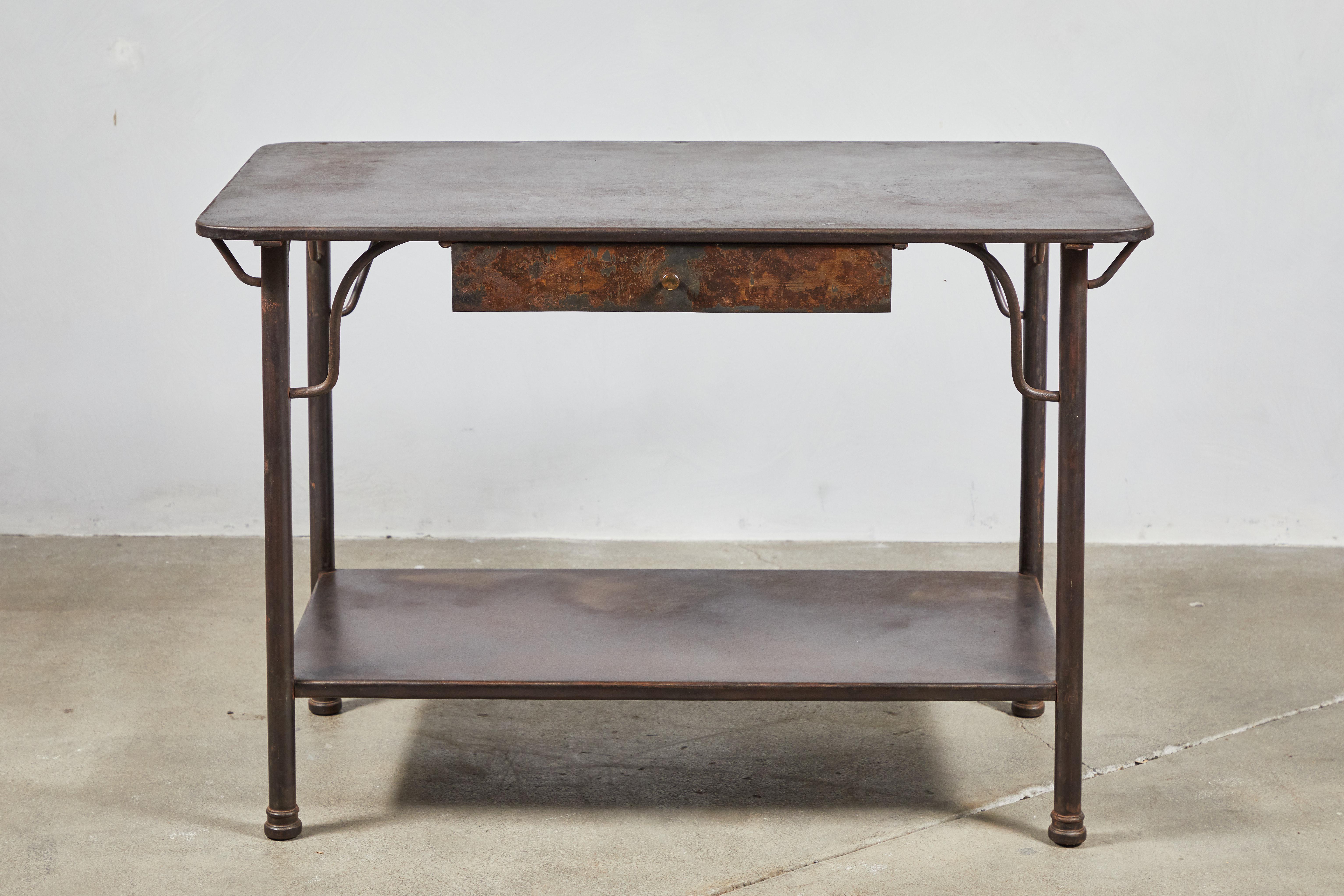 Vintage French metal table with lower shelf and single drawer. The table also makes for a great console.