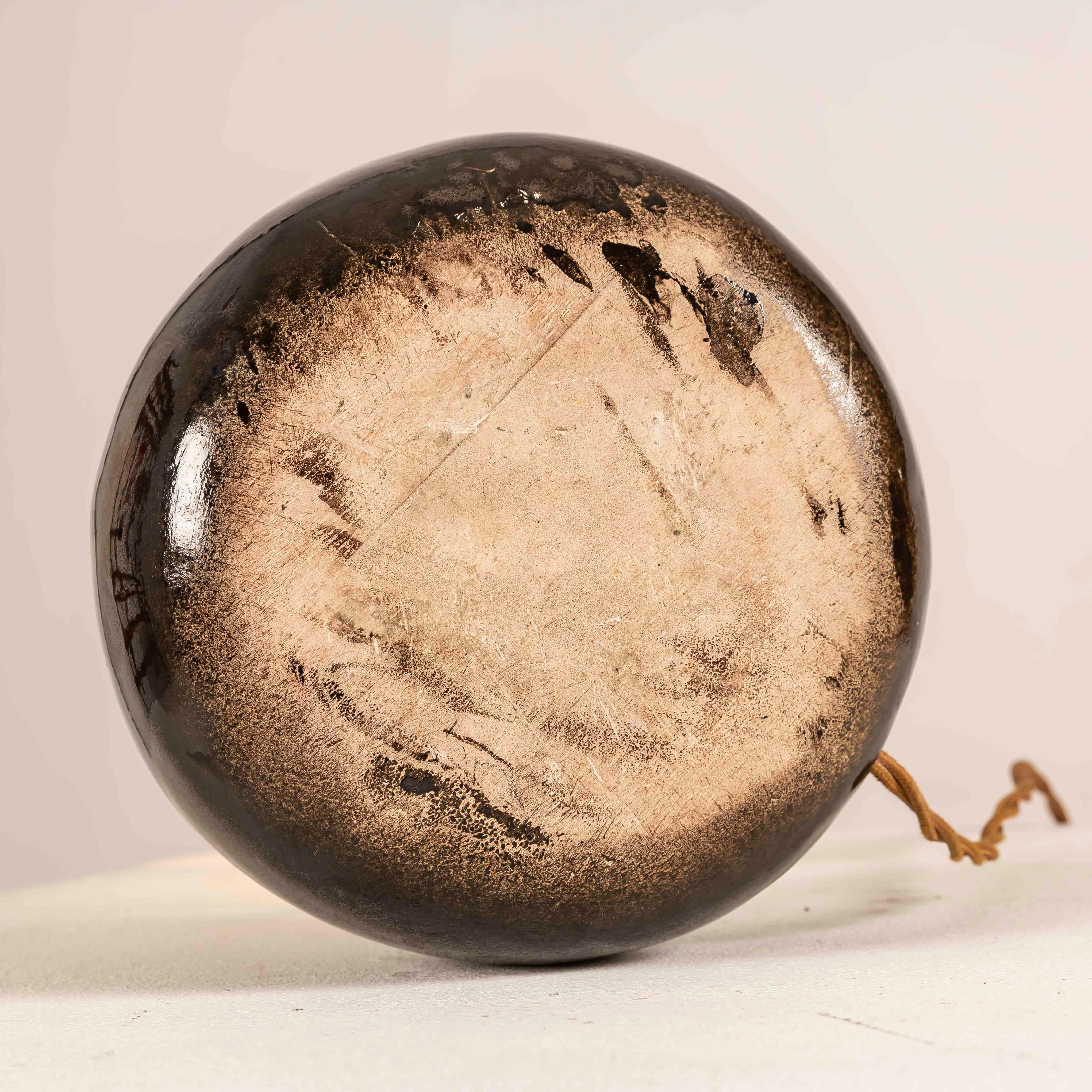 French Mid-Century ceramic table lamp, Vallauris/Accolay school, circa 1955–65. The hand-thrown boule body is finished in a deep metallic lustre glaze—bronze/smoked mirror—with a fine intentional craquelure that adds texture and character. A short