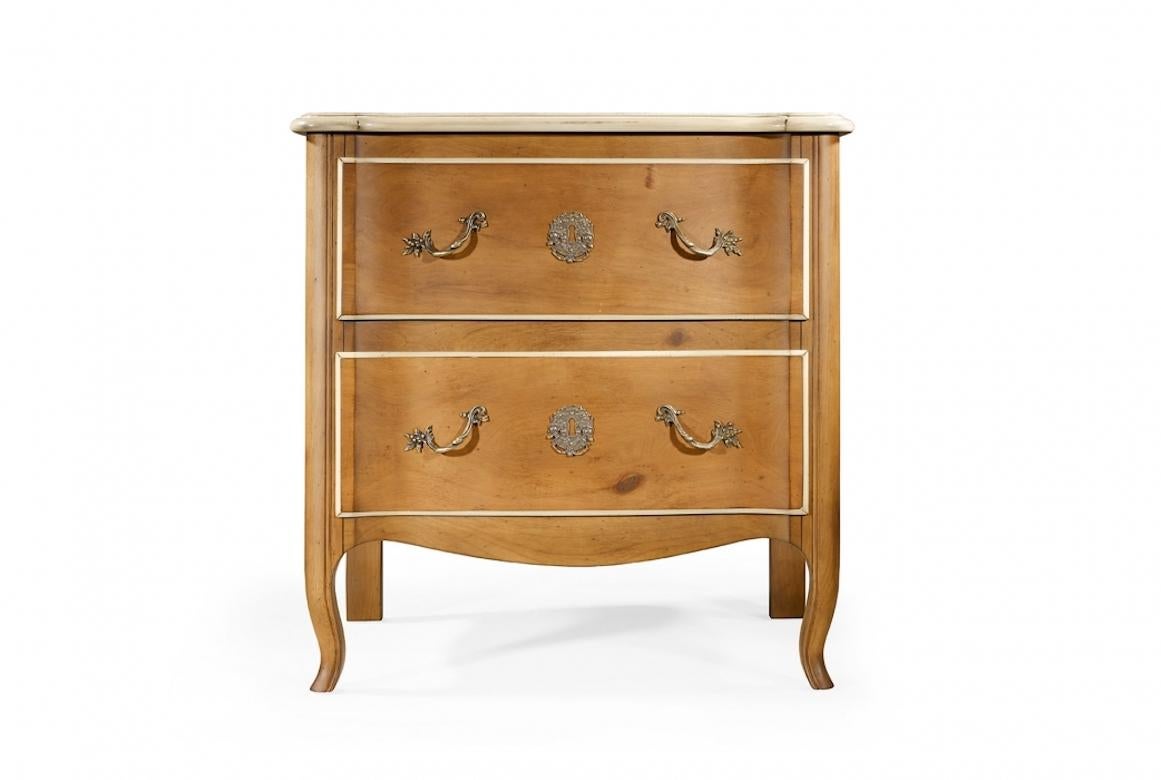 A stunning French Michelet Louis XVI bedside table, 20th century.

The Michelet bedside table is shown in cherry wood with a Biarritz finish and details in dusty white. It has two large drawers and curved Louis XV legs en cabriolet. Note the