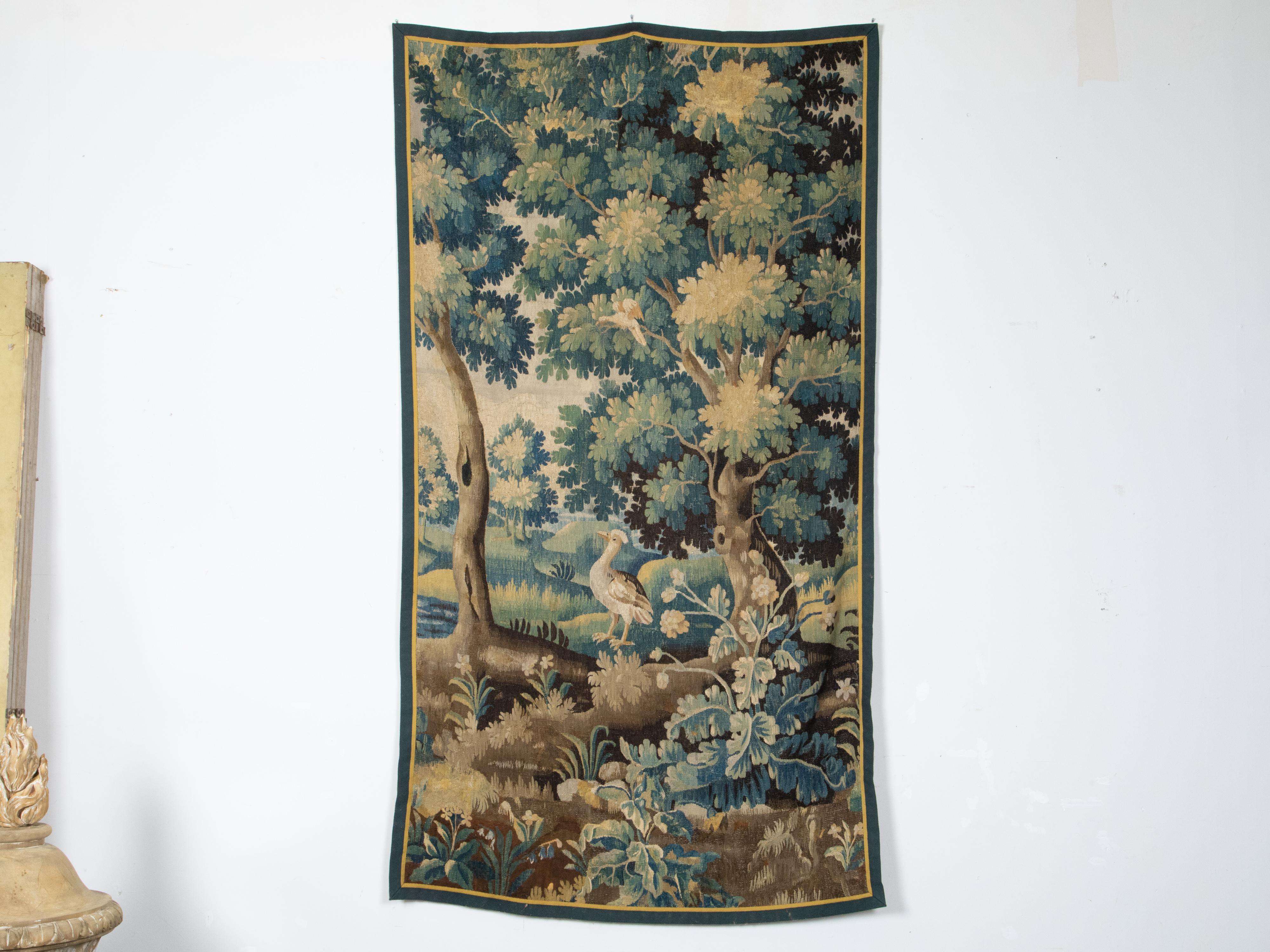 A French Royal Manufacture of Aubusson woven tapestry from the mid 18th century depicting a bird standing in luscious vegetation. Created during the Mid-18th Century in the Aubusson manufactures located in central France, this vertical woven